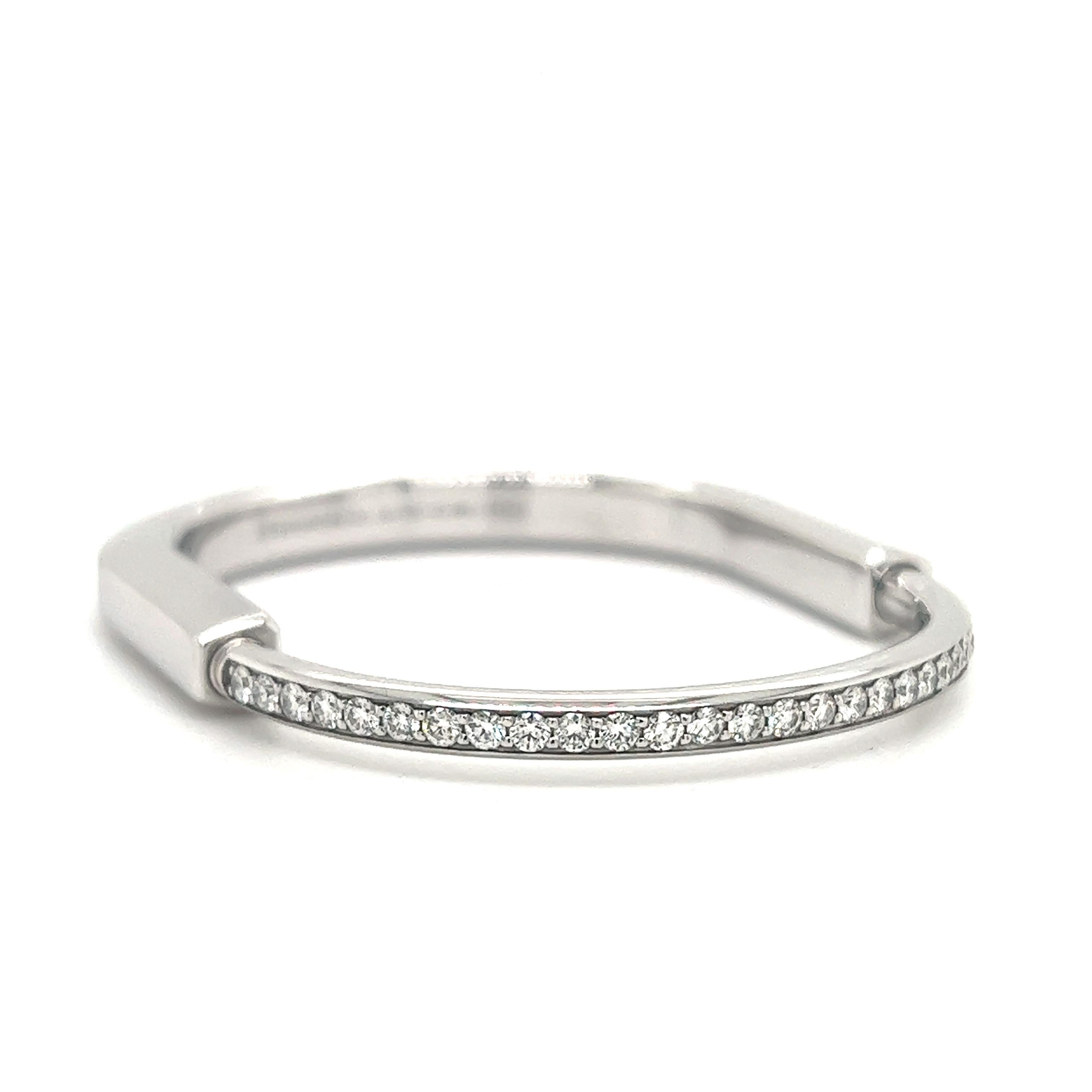 Beautiful new design from famed designer Tiffany  & Co. This design is known as the Tiffany & Co.  lock  bangle crafted in 18k white gold and set with 1.08 ct. natural diamonds. The bracelet is a size small and  will  fit a  5.75