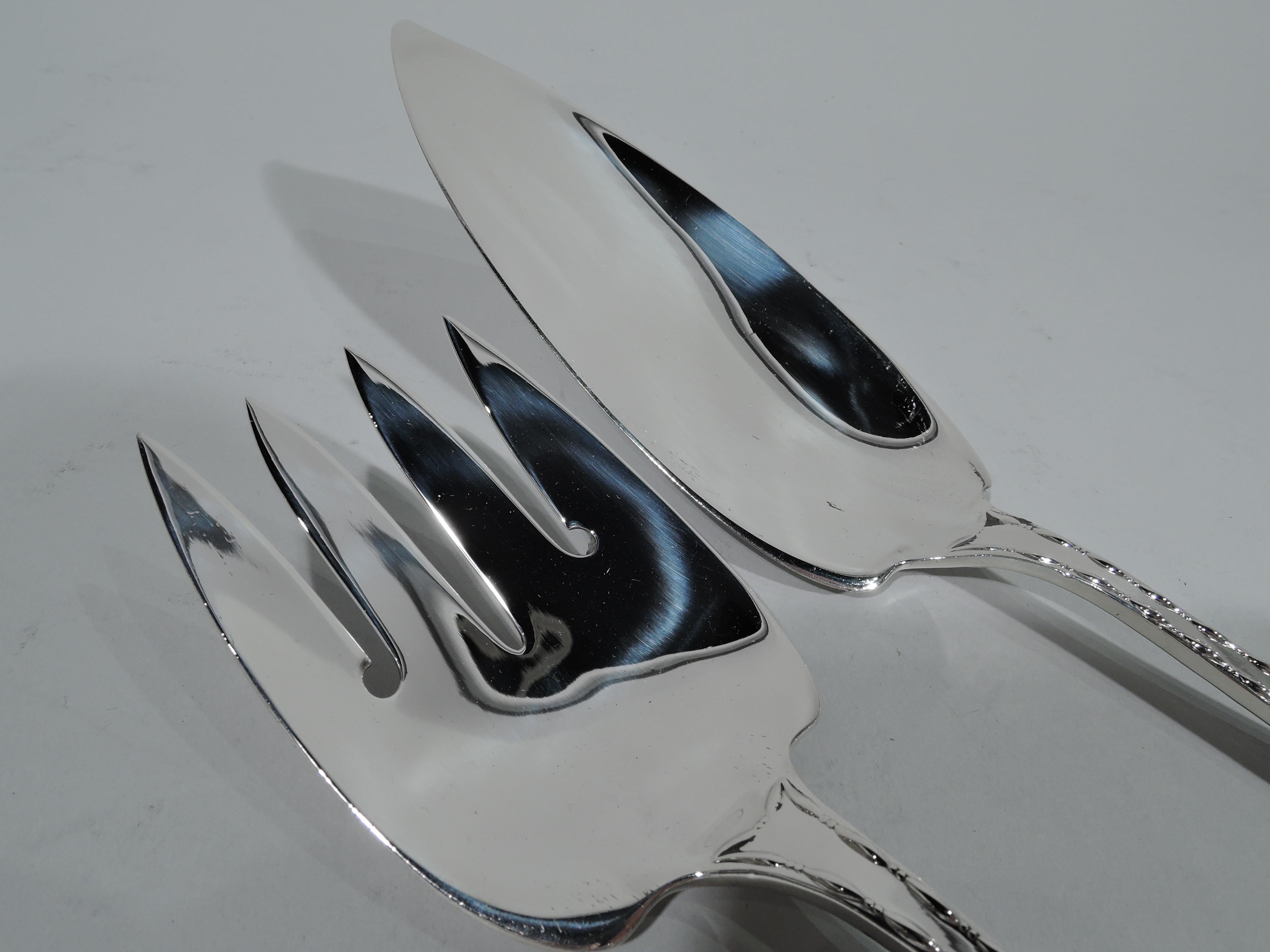 Classical sterling silver fish slice and fork in Marquise pattern. Made by Tiffany & Co. in New York. Beautiful serving pieces with raised bead-and-reel borders. Fork has 4 wide tines and slice has narrow and tapering blade. This pattern first