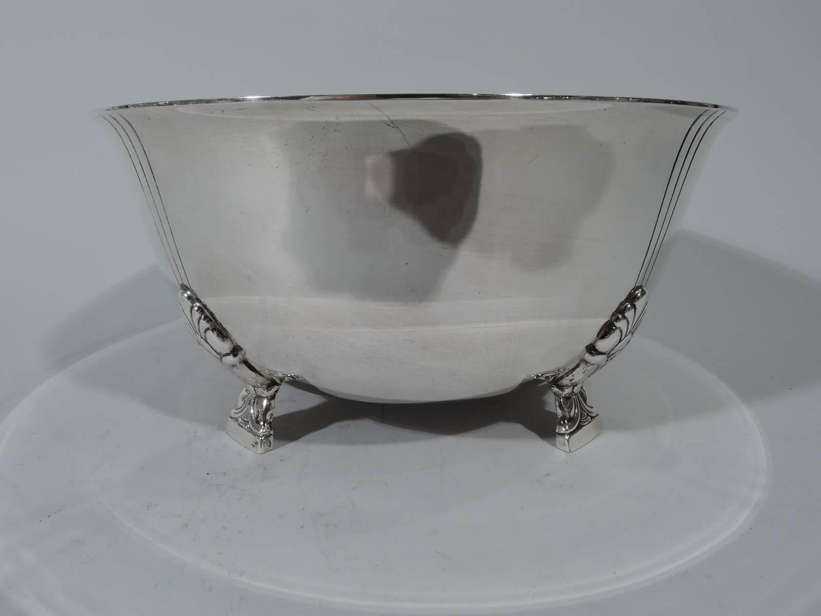 Classic sterling silver bowl in Palmette pattern. Made by Tiffany & Co. in New York. Curved sides and flared rim. Rests on four side-mounted stylized floral supports. Each support radiates three incised and vertical lines. An early piece in this