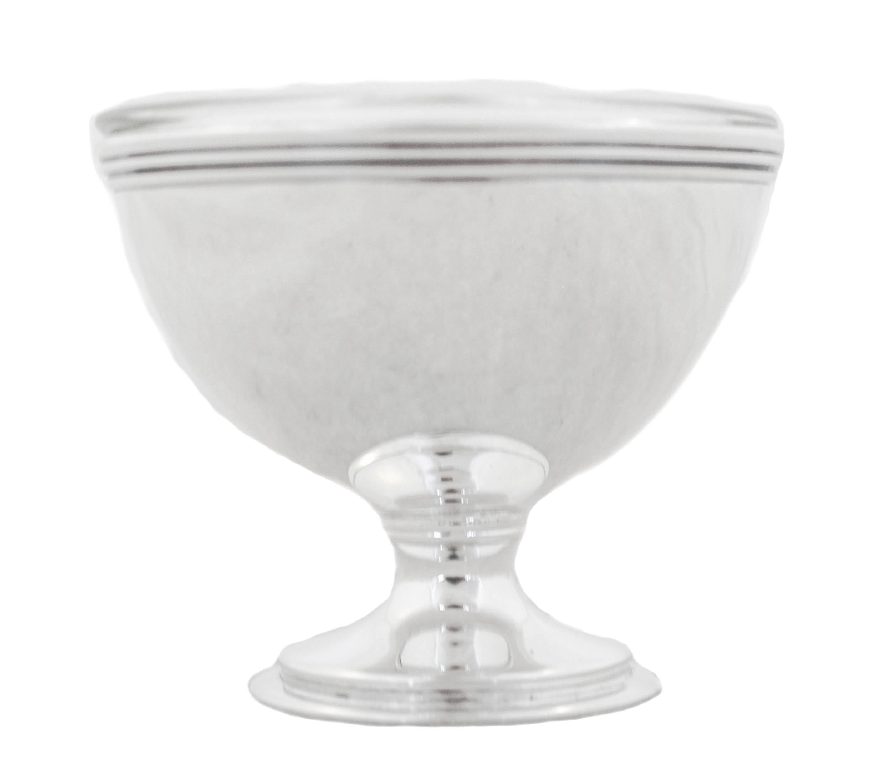 Mid-Century sterling silver salt shaker & cellar by the world renowned Tiffany & Company.  A tailored and clean look make for a sophisticated and elegant set.  The salt cellar has a clear glass liner so you can leave the salt in it without worrying