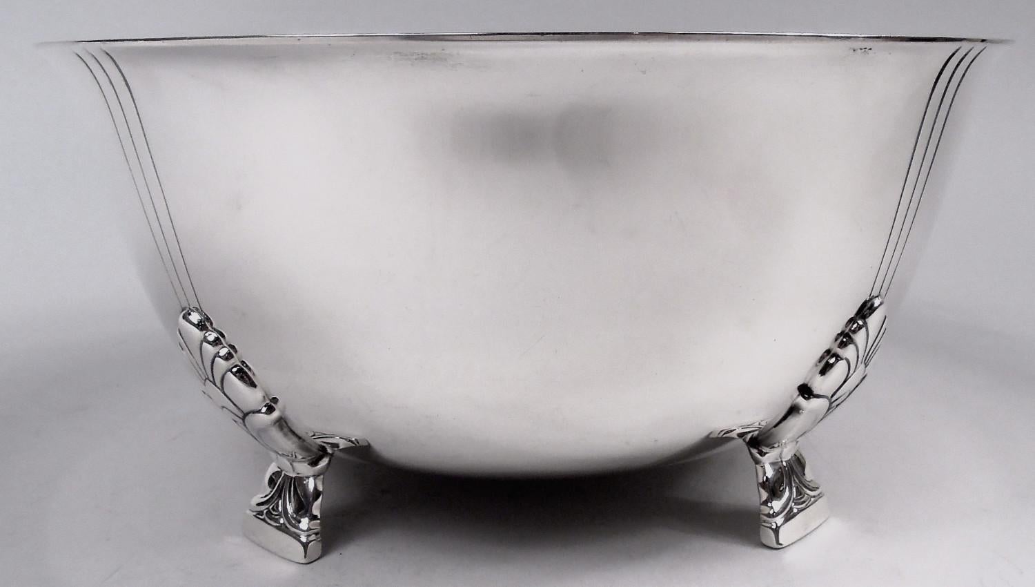 Palmette sterling silver bowl. Made by Tiffany & Co. in New York. Curved sides and flared rim. Rests on 4 side-mounted stylized floral supports. Each support radiates 3 incised vertical lines. An early piece in this pattern, which was first produced