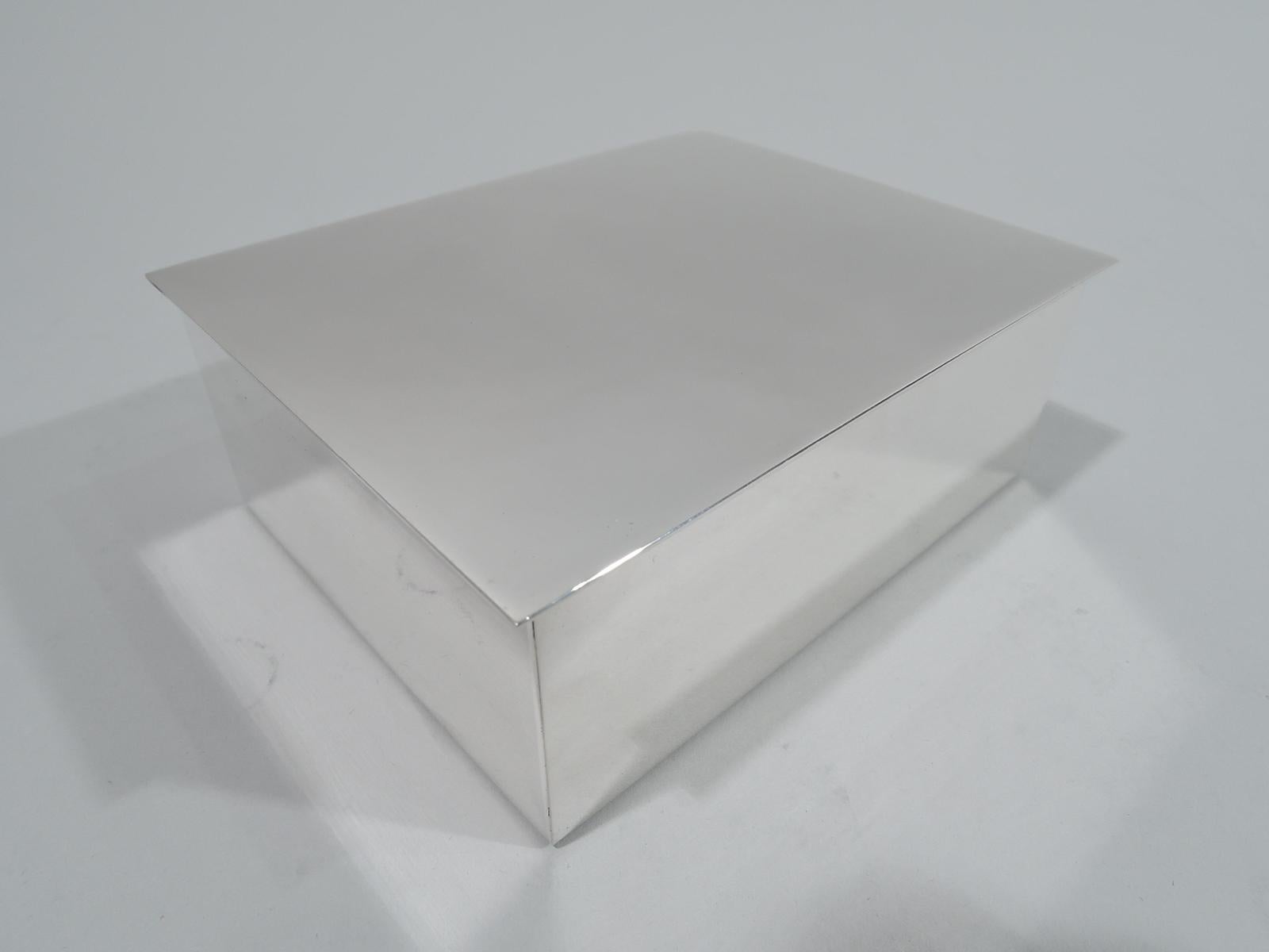 Mid-Century Modern sterling silver box. Made by Tiffany & Co. in New York. Rectangular with straight sides. Cover flat, hinged, and overhanging. Box interior cedar lined. Fully marked including maker’s stamp, postwar pattern no. 23325, and