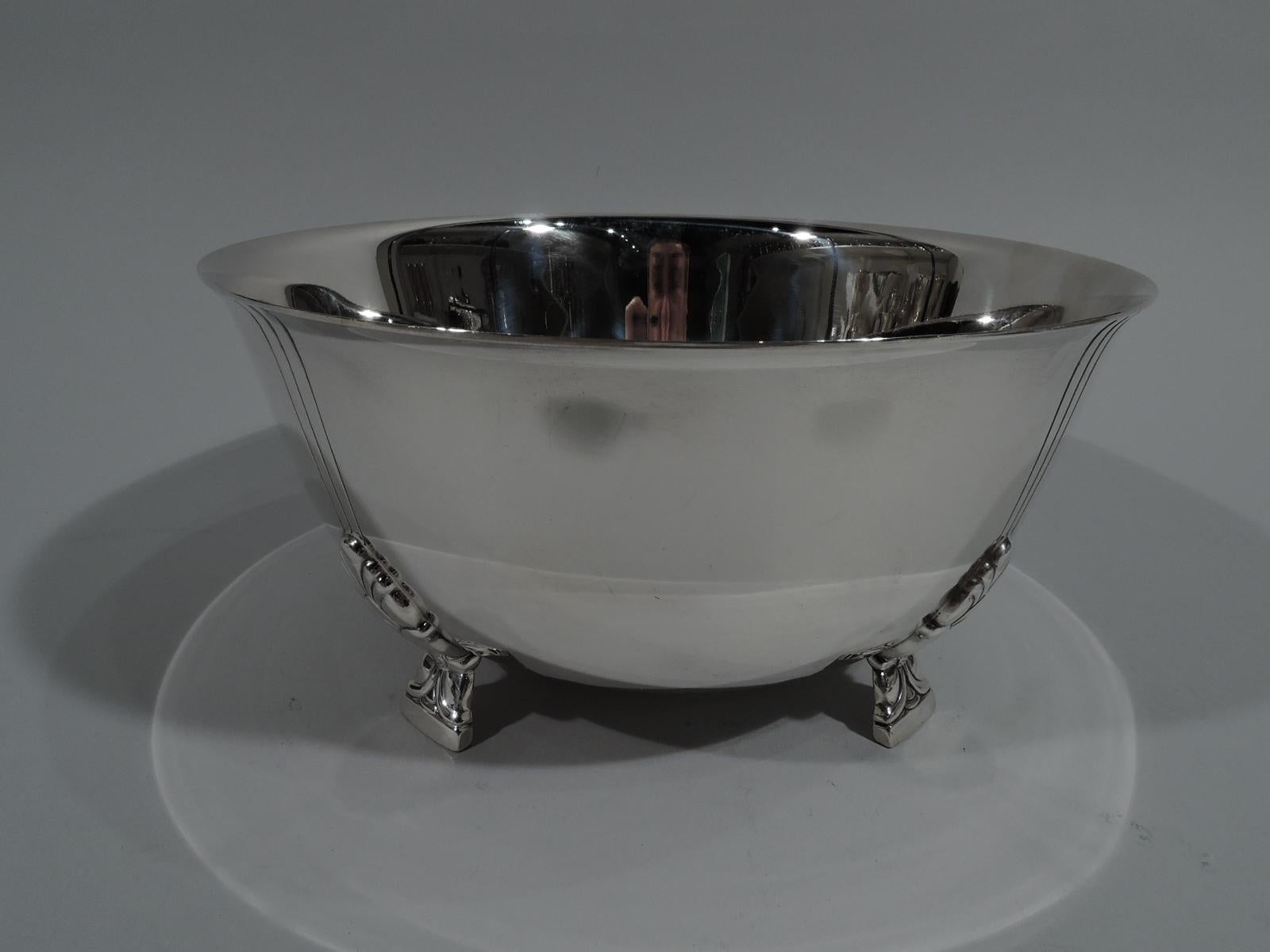 Classic sterling silver bowl in Palmette pattern. Made by Tiffany & Co. in New York. Curved sides and flared rim. Rests on 4 side-mounted stylized floral supports. Each support radiates 3 incised vertical lines. An early piece in this pattern, which