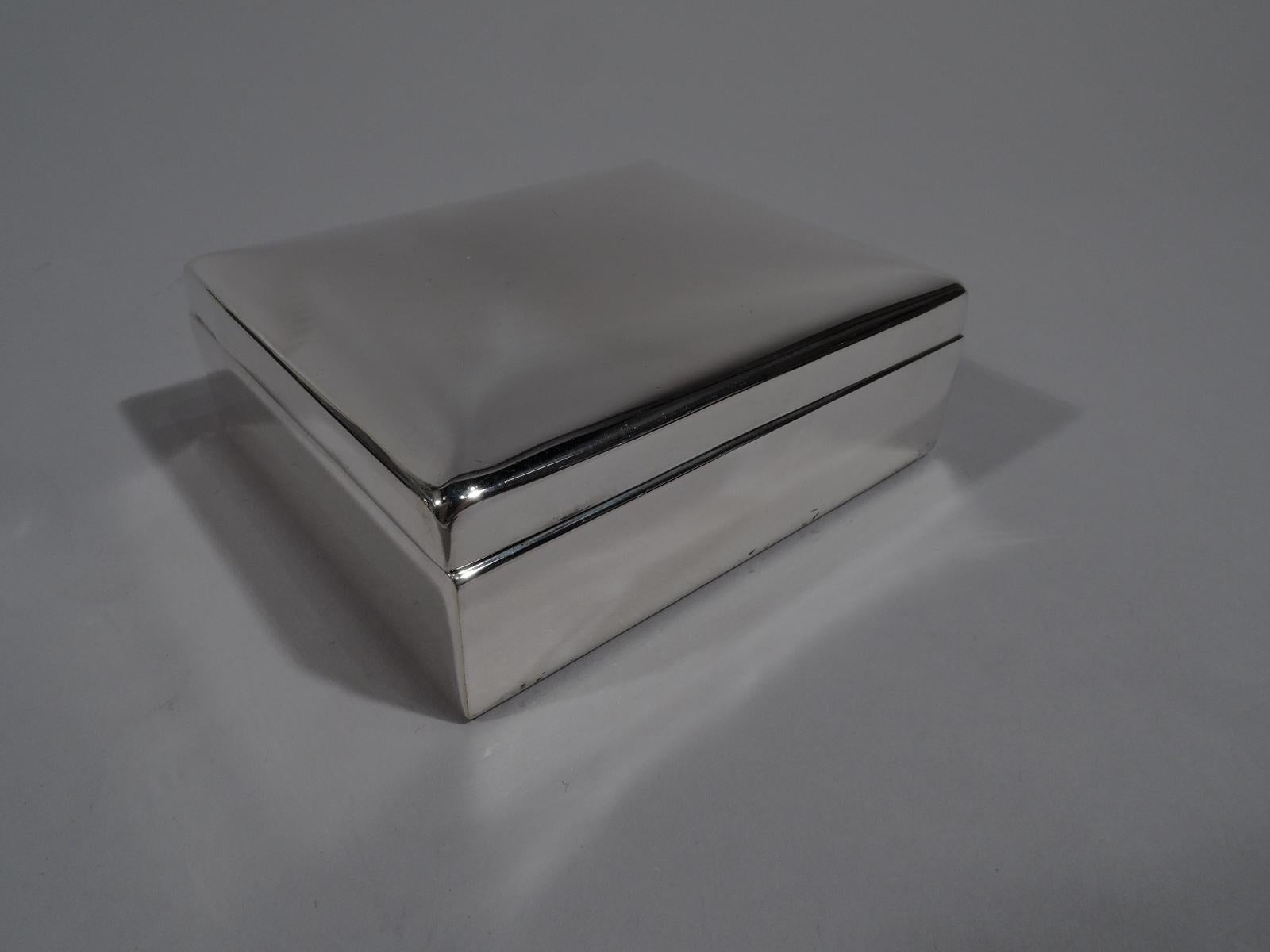 Mid-Century Modern sterling silver box. Rectangular with straight sides. Cover gently raised. Box interior velvet lined. Cover interior gilt washed. The perfect receptacle for trinkets and bits of jewelry. Fully marked including postwar pattern no.