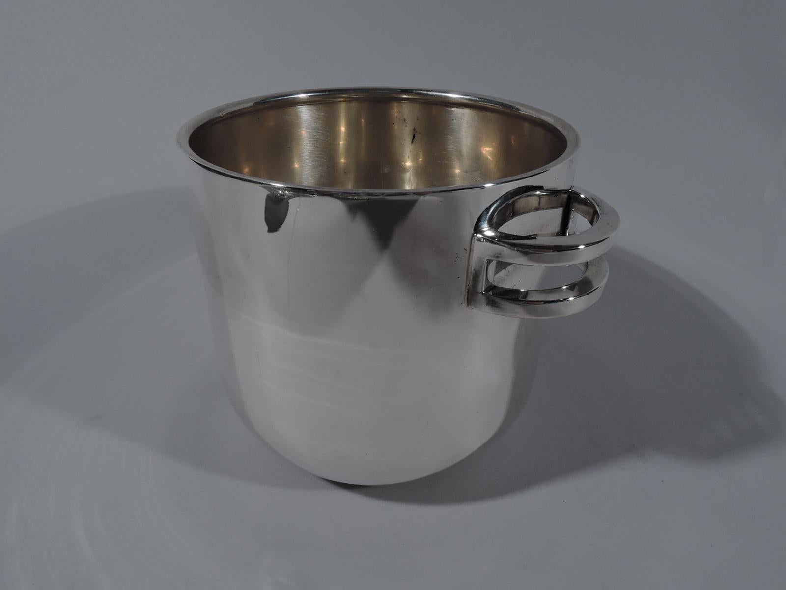 Modern Classical ice bucket. Retailed by Tiffany & Co. in New York. Urn with open double c-scroll side handles that hold the tongs. Marked “Tiffany & Co. Sterling / Italy”. Heavy weight: 23 troy ounces.