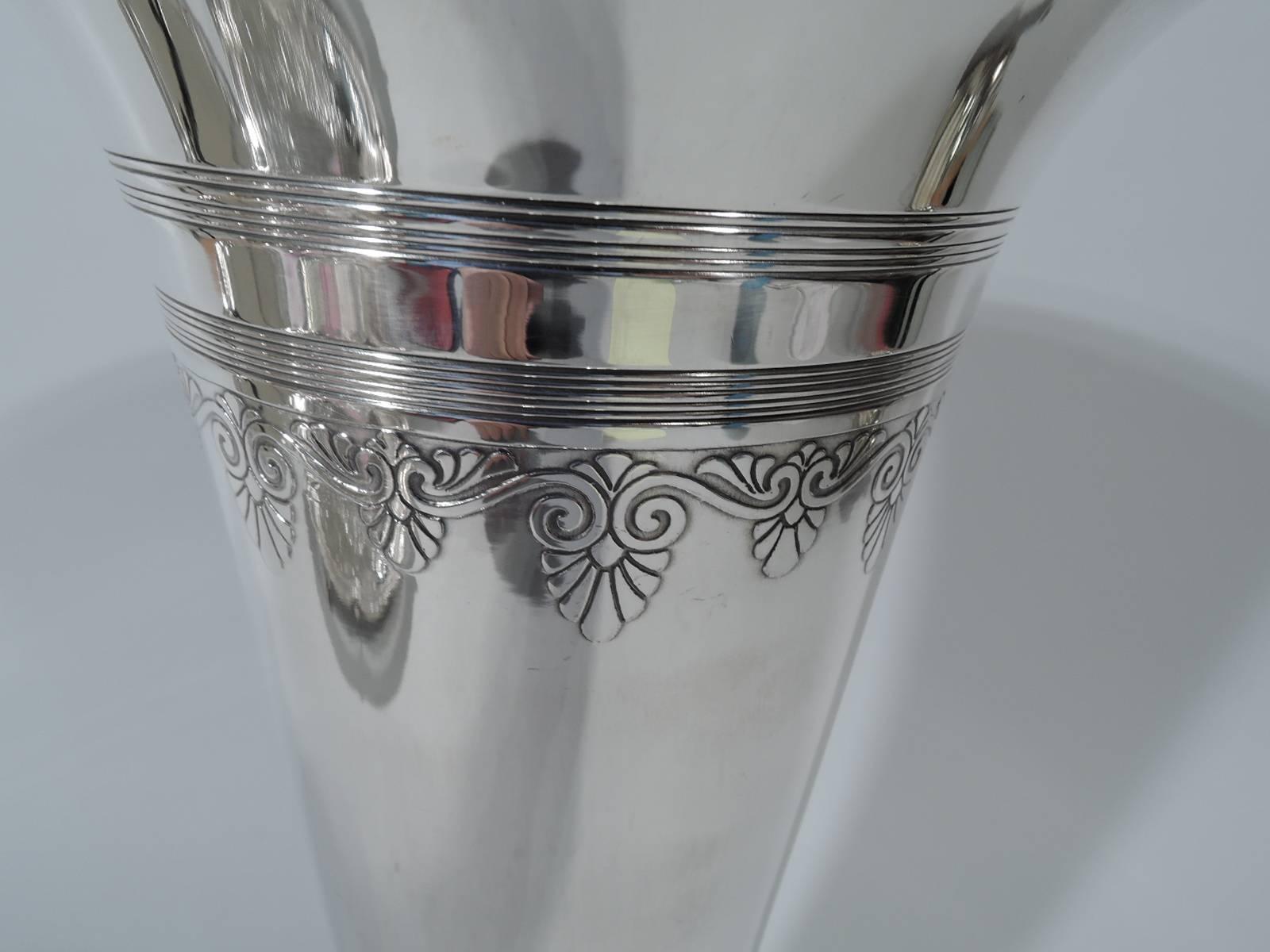 Modern classical sterling silver vase. Made by Tiffany & Co. in New York. Straight and tapering sides with flared rim and short stem on stepped round foot. Engraved reeding and acid-etched bands with palmettes, volute scrolls, and leaves. Hallmark