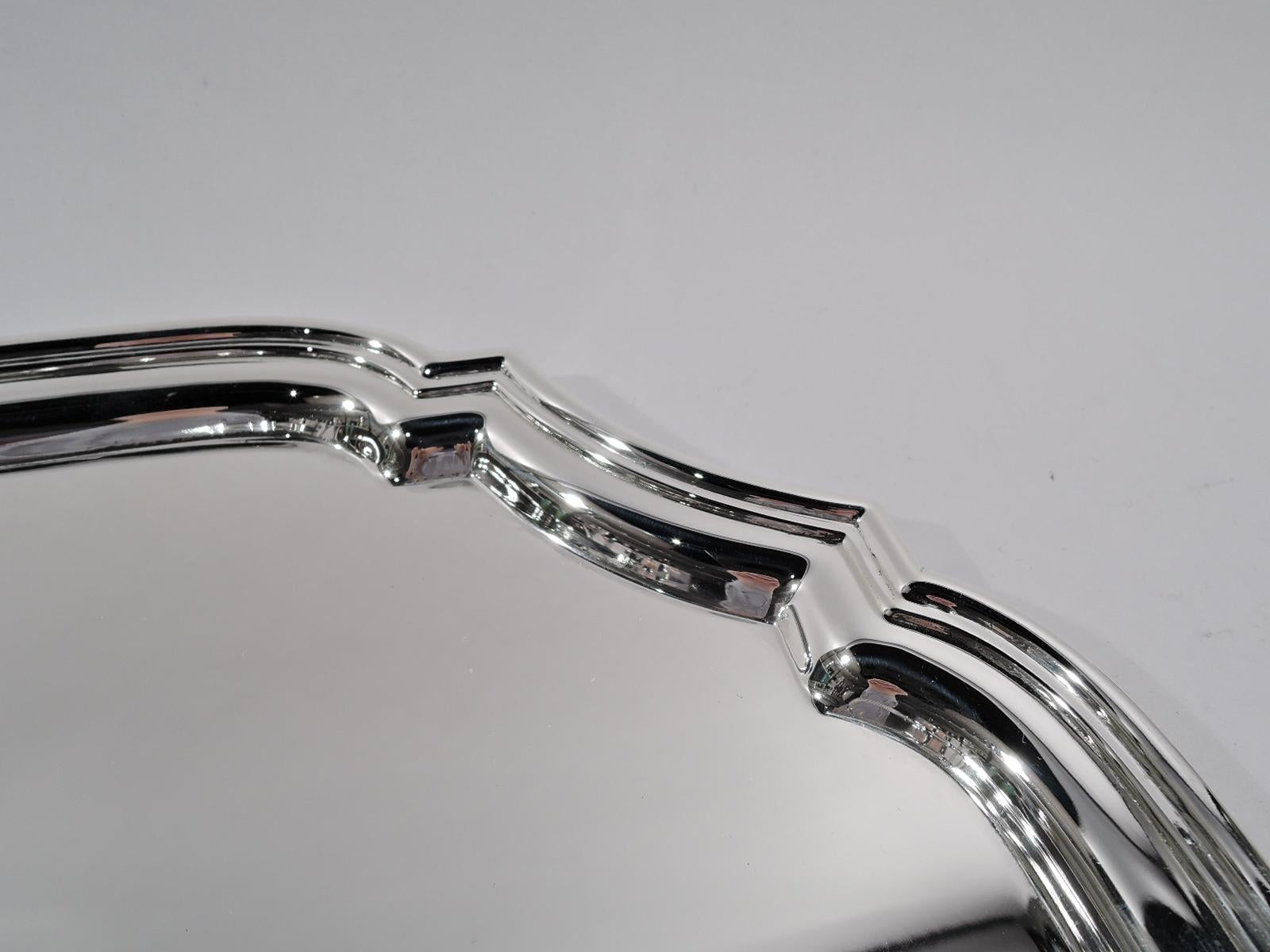 Modern Georgian sterling silver tray. Made by Tiffany & Co. in New York. Curvilinear cartouche with four curved sides, concave corners, and molded rim. Fully marked including postwar pattern no. 25142. Weight: 19.5 troy ounces.