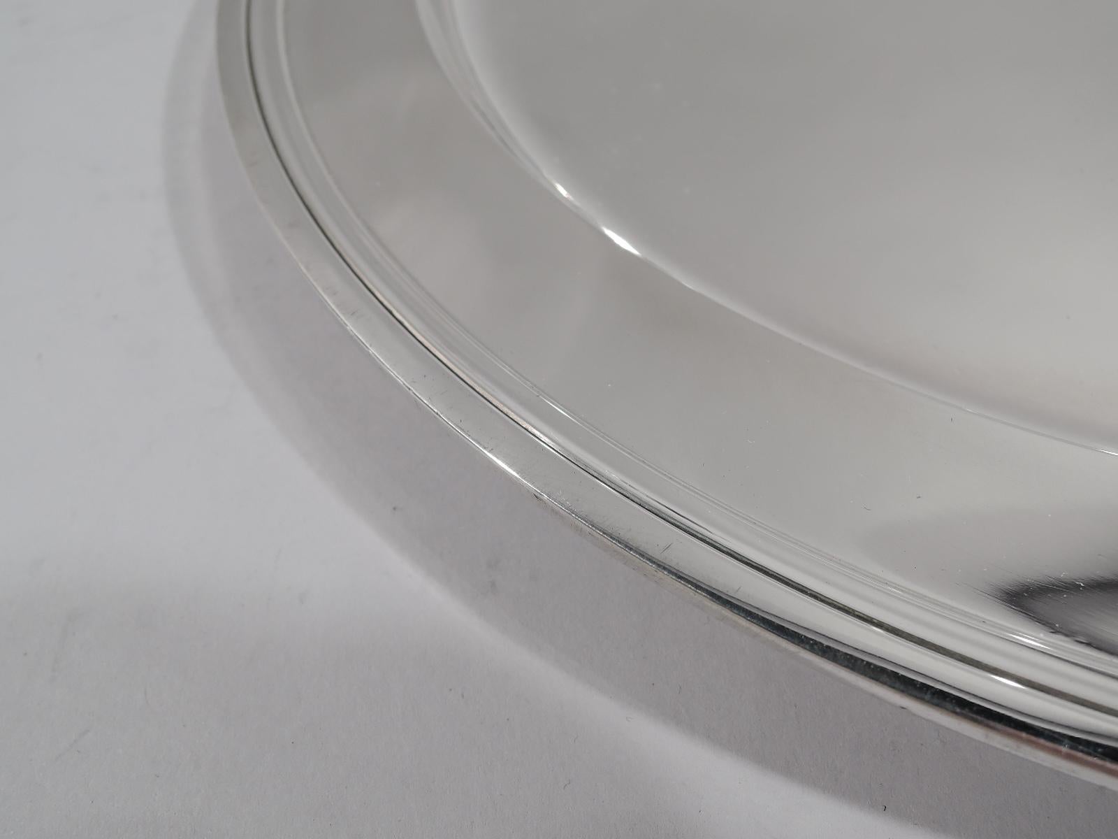Modern sterling silver serving tray. Made by Tiffany & Co. in New York. Round with deep well and molded rim. Fully marked including pattern no. 20187, director’s letter M (1947-1956), and diameter. Weight: 21.5 troy ounces.