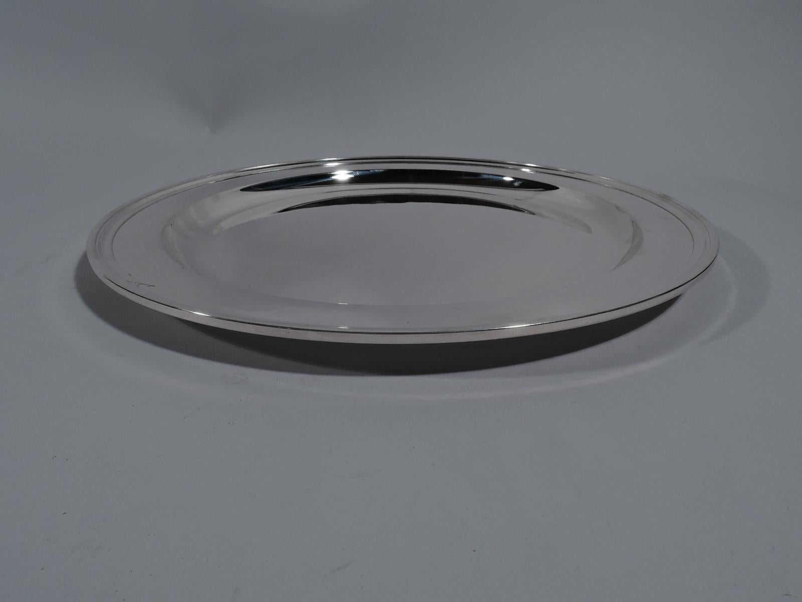 Modern sterling silver serving tray. Made by Tiffany & Co. in New York. Round with deep well and molded rim. Fully marked including pattern no. 20187. Weight: 22 troy ounces. Measure: 12 inch.