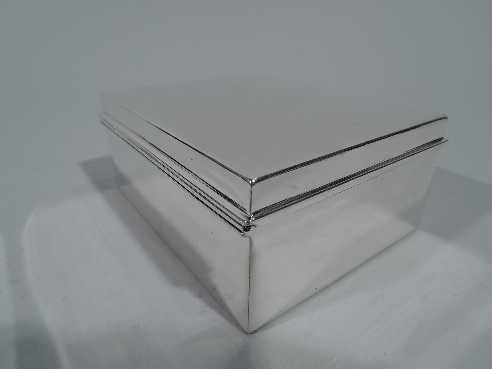 Modern sterling silver desk box. Made by Tiffany & Co. in New York. Rectangular with straight sides. Cover flat and hinged with molded rim. Box interior cedar-lined. Cover interior gilt. Hallmark includes pattern no. 22355, director’s letter m