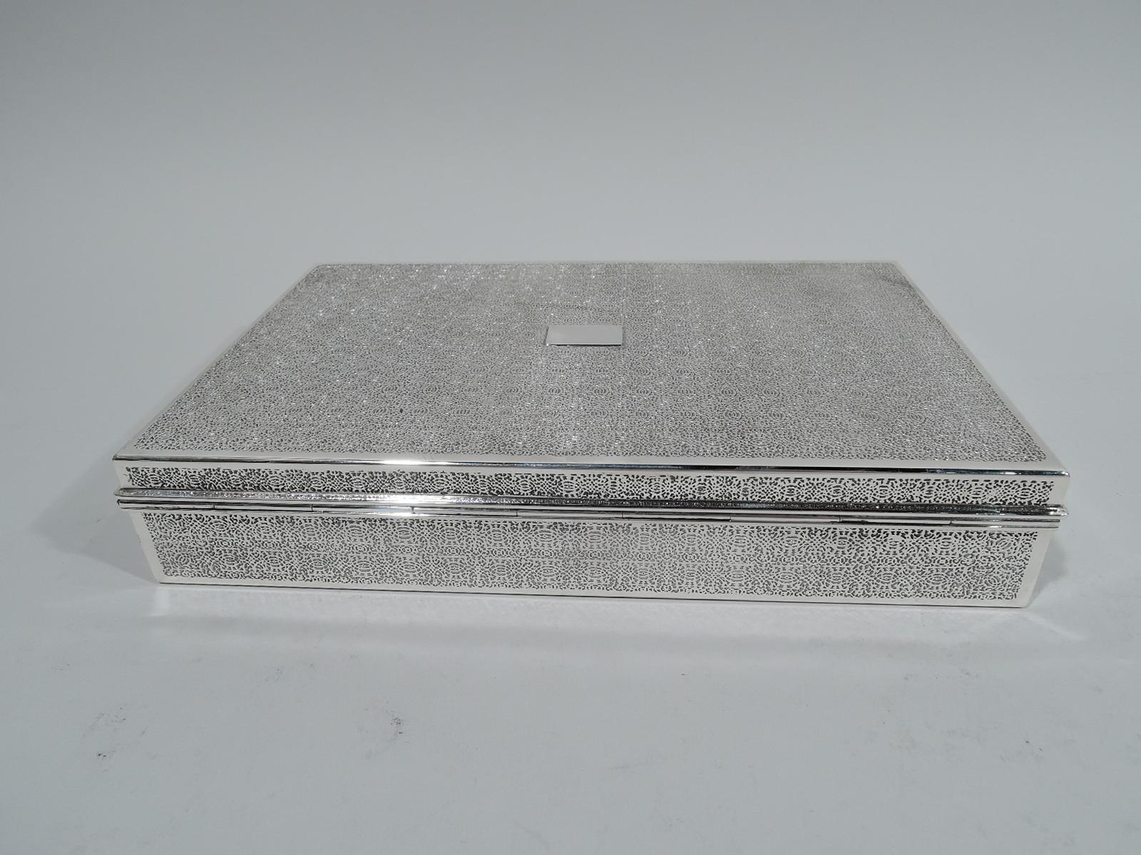 Modern sterling silver desk box. Made by Tiffany & Co. in New York, circa 1936. Rectangular with straight sides. Cover flat and hinged with molded rim. The classic form embellished with dense and interlacing acid-etched repeating pattern on cover