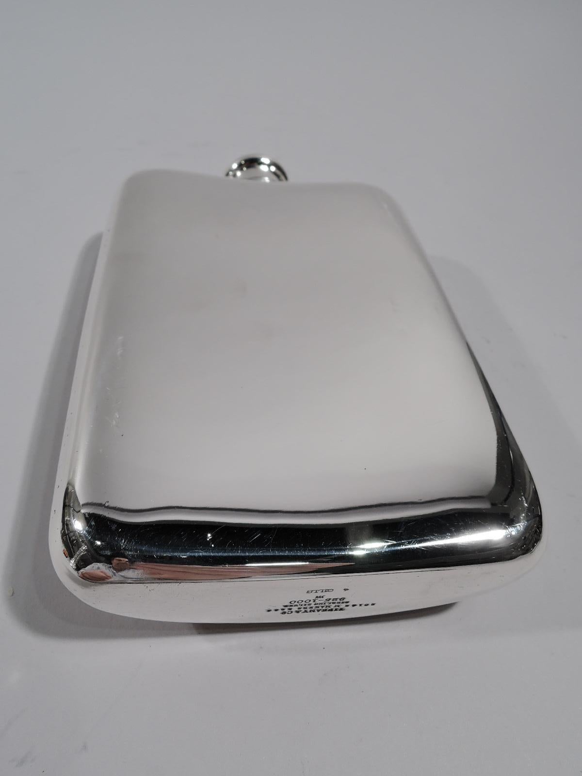 Modern sterling silver flask. Made by Tiffany & Co. in New York, circa 1922. Rectilinear, and hinged and cork-lined cover. Front curved with camel silhouette on enameled purple ground, a buoyant dromedary that has slaked its thirst. Fully marked