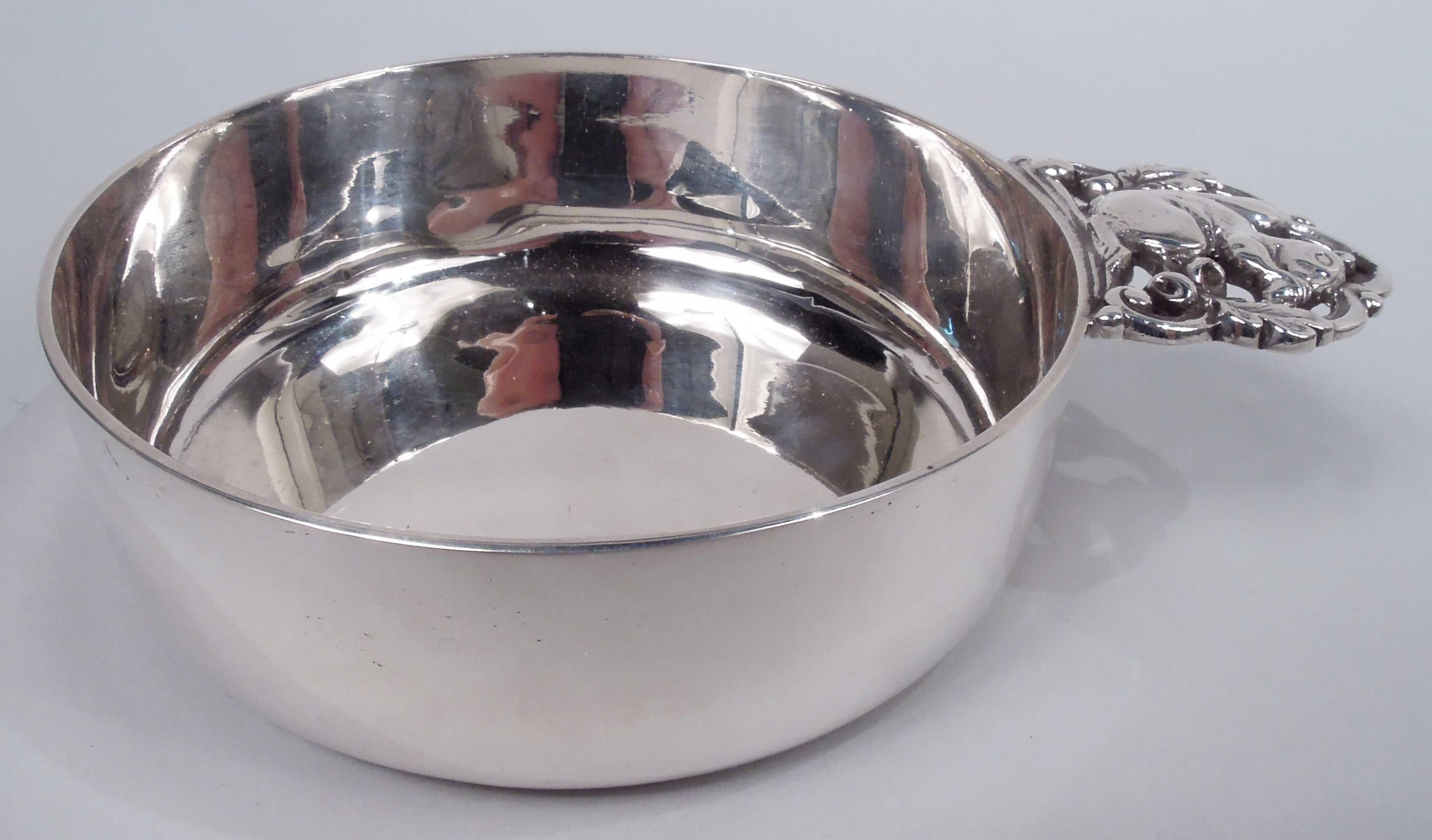 Modern sterling silver porringer. Made by Tiffany & Co. in New York. Round with straight sides. Cast open cinquefoil handle inset with acorn-nibbling squirrel. Fully marked including maker’s stamp, pattern no. 23111, director’s letter m (1907-47),