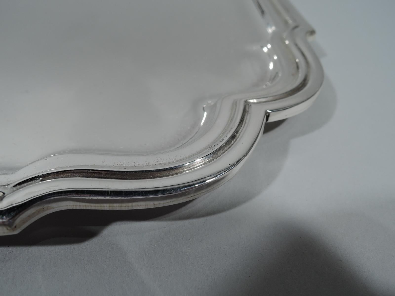 Modern sterling silver serving tray. Made by Tiffany & Co. in New York. Square with molded rim and double-scrolled corners. Hallmark includes postwar pattern no. 25082. Heavy weight: 47 troy ounces.