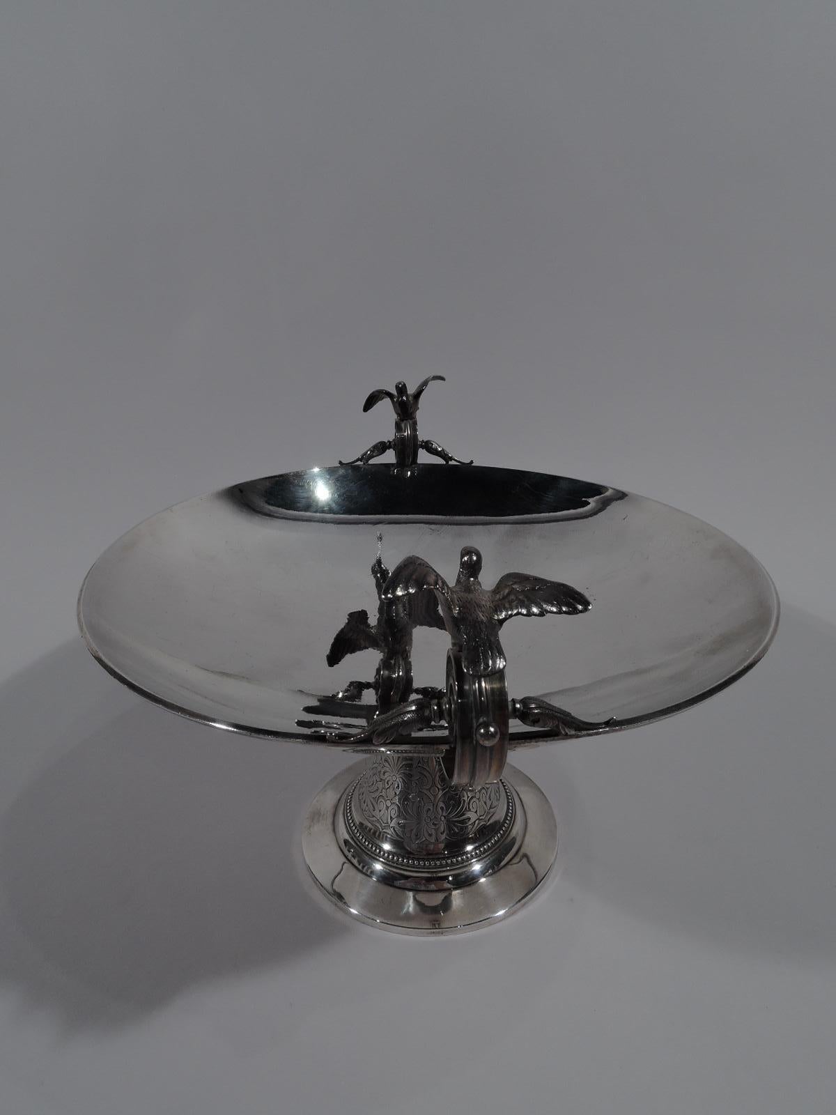 Aesthetic sterling silver compote. Retailed by Tiffany & Co. in New York, circa 1870. Shallow round bowl mounted to conical support on flat foot. A spare form suggestive of the Greek kylix with low and deep side handles terminating in volute scrolls