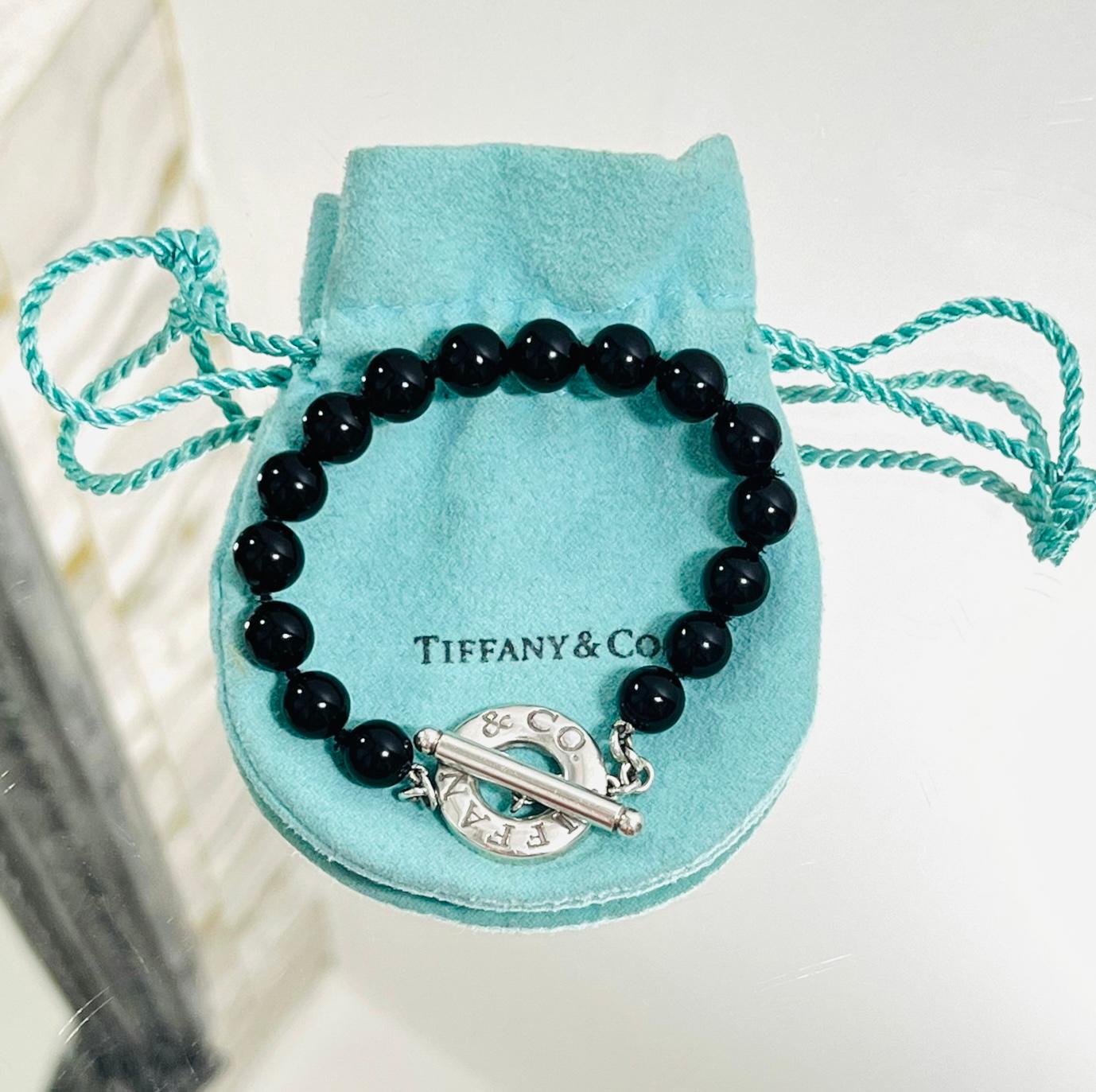 Tiffany Onyx & Sterling Silver Toggle Bracelet

Black onyx bead bracelet designed with silver toggle closure featuring 'Tiffany & Co' engravement.

Size – One Size

Condition – Very Good

Composition – Onyx, 925 Sterling Silver

Comes with – Pouch