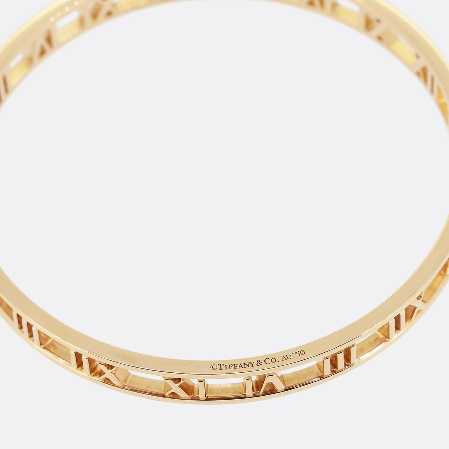 This is an 18ct rose gold bangle from the luxury jewellery designer Tiffany & Co. The bangle forms part of the atlas collection and has the iconic Roman numeral design. This is a slip on model so please take note of the measurements. It is the