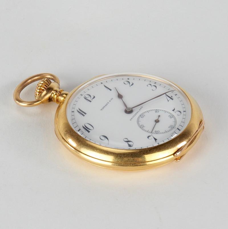An 18 karat yellow gold open faced pocket watch made by Agassiz & Co. for Tiffany & Co. Auguste Agassiz was the founder of the Swiss watch manufacturer Longines. 

White single sunk dial signed TIFFANY & CO., Arabic numerals, blued steel spade