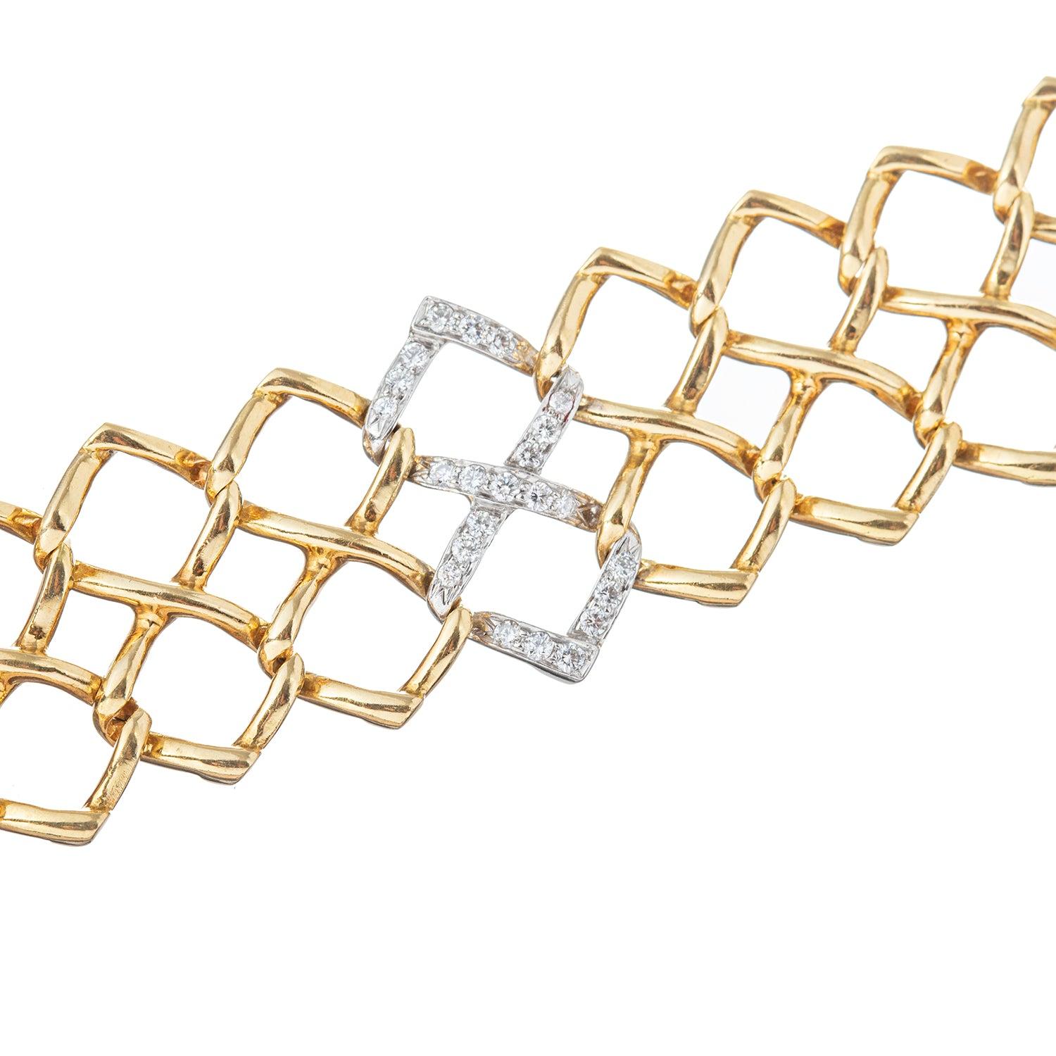 Openwork double link bracelet in polished 18k yellow gold with one of the double links accented by round brilliant-cut diamonds in platinum.

Twenty-three diamonds weighing 0.33 total carats.  Signed '1982 TIFFANY & CO. PALOMA PICASSO'.  6.75