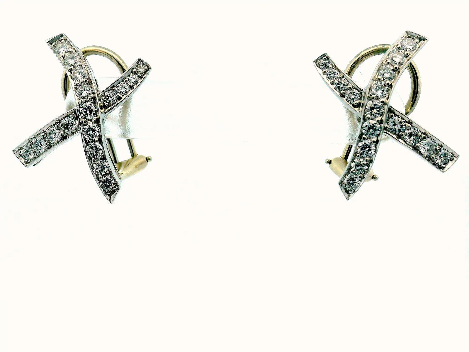 Discover the elegance of these diamond earrings, crafted in 1980.

Featuring 1.36 carats of round white diamonds, these earrings radiate brilliance.

The diamonds are set in luxurious platinum with a clarity of VS1 and a D color grade.

Created by