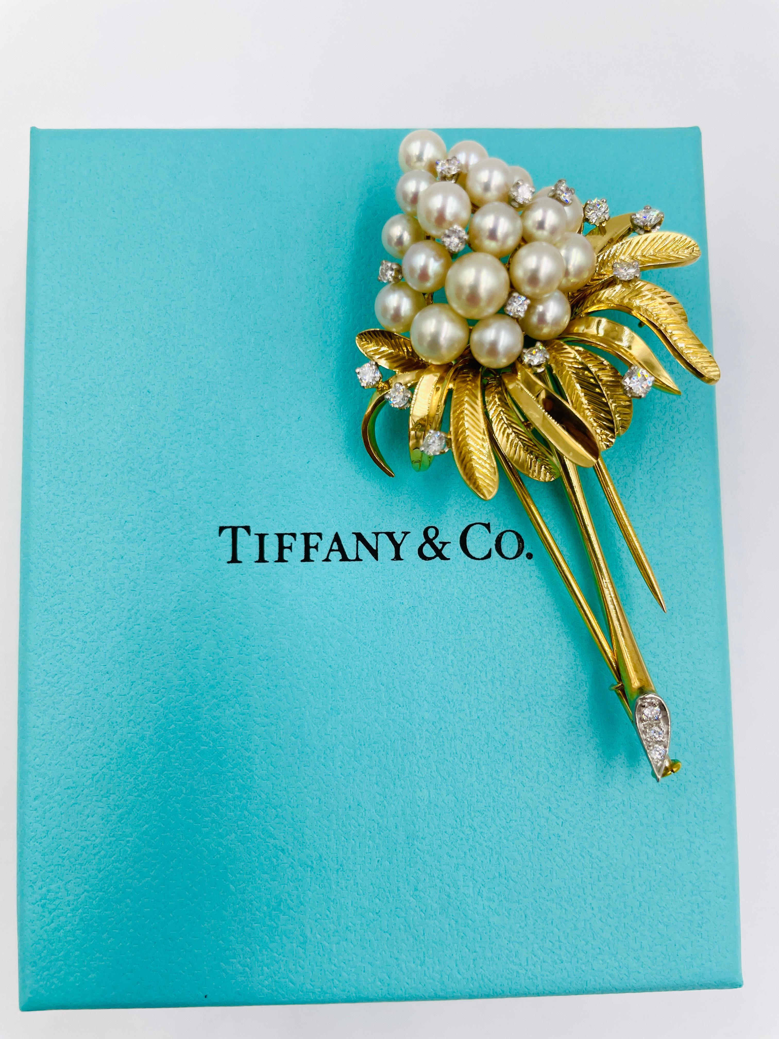 Tiffany pearl and diamond yellow gold brooch, circa 1970s.

ABOUT THIS ITEM: P-CDJ1012.  Scroll down for specifications.  This Tiffany specially designed floral brooch is set with various-sized round Akoya cultured pearls and round diamonds.  Custom