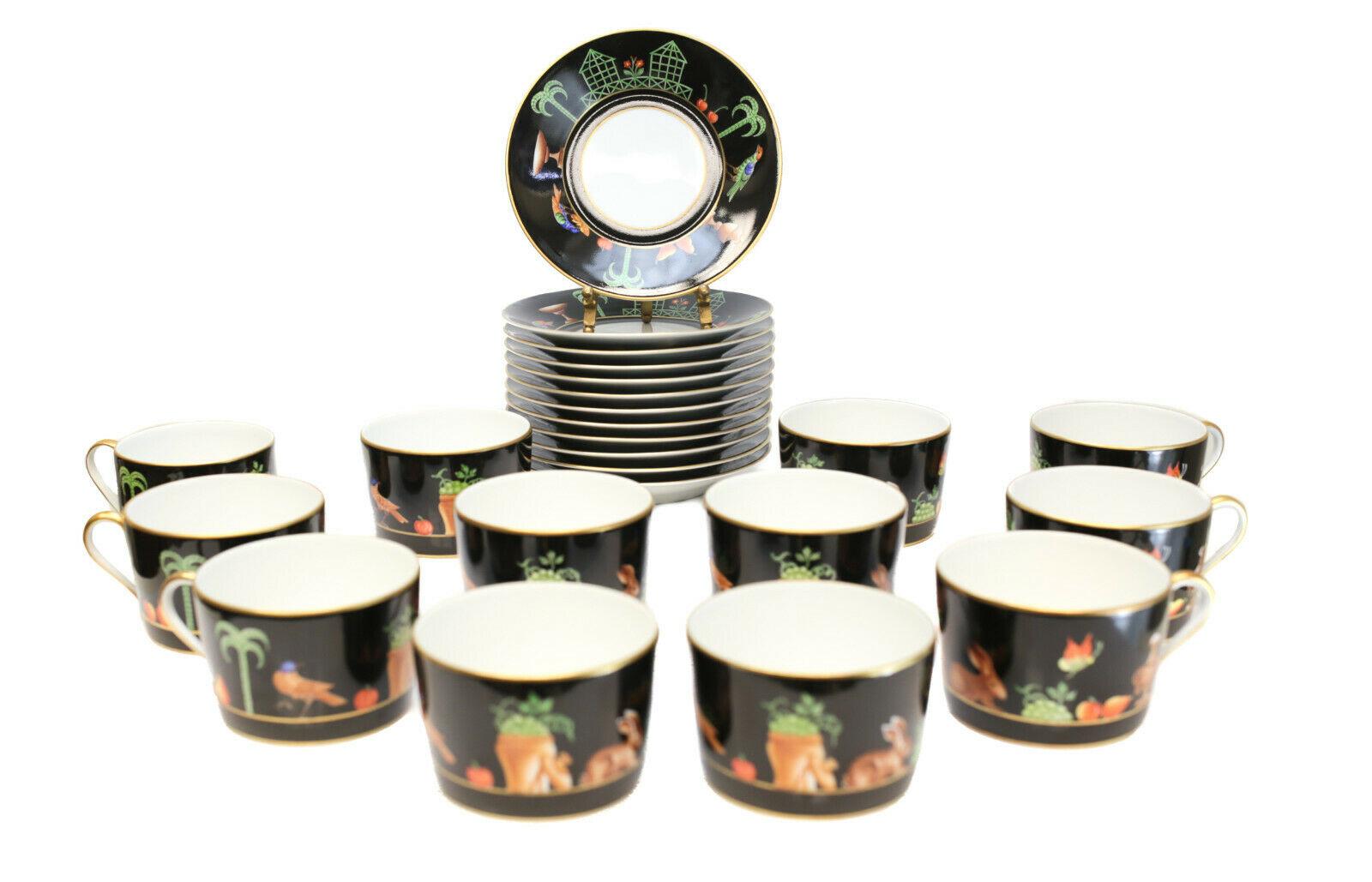12 Tiffany private stock Le Tallec porcelain tea cup and saucers in black shoulder. Beautiful hand painted tropical birds, trees, fruits, and rabbits to a black and gilt ground. Tiffany private stock mark with the Le Tallec mark and artist initials