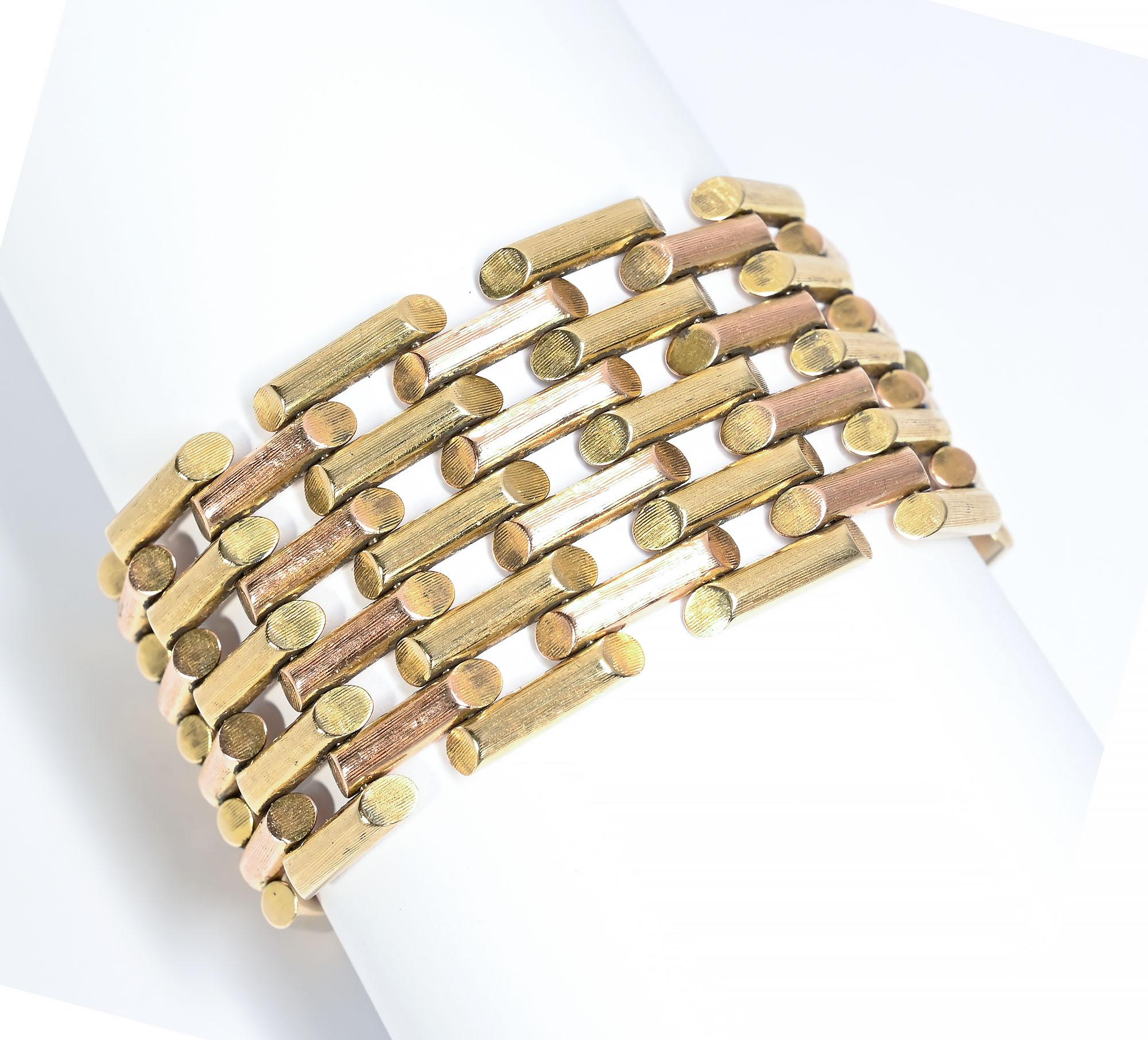 Retro bracelet by Tiffany with alternating bars of pink and yellow gold.  Each link has a lightly brushed surface. The bracelet measures 6 7/8 inches long and 1 1/4 inches wide. The bracelet is bold due to its width yet light because of the