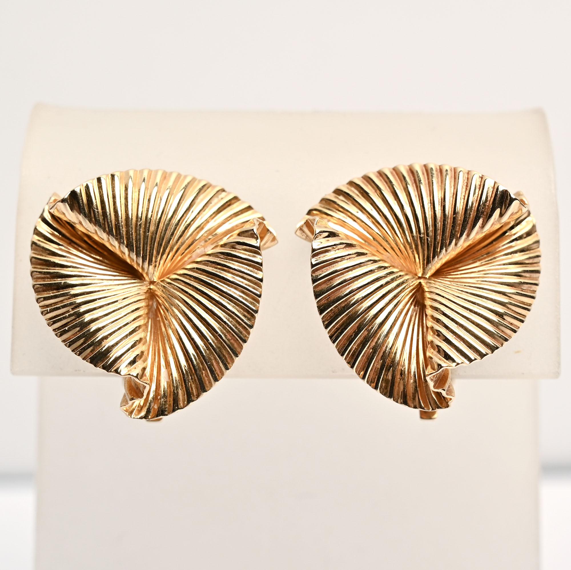These classic Tiffany design earrings are the mates to the brooch listed as item LU13321851832. They consist of three undulating, overlapping  floral lobes with a striated pattern. The earrings have clip backs that can be converted to posts, They