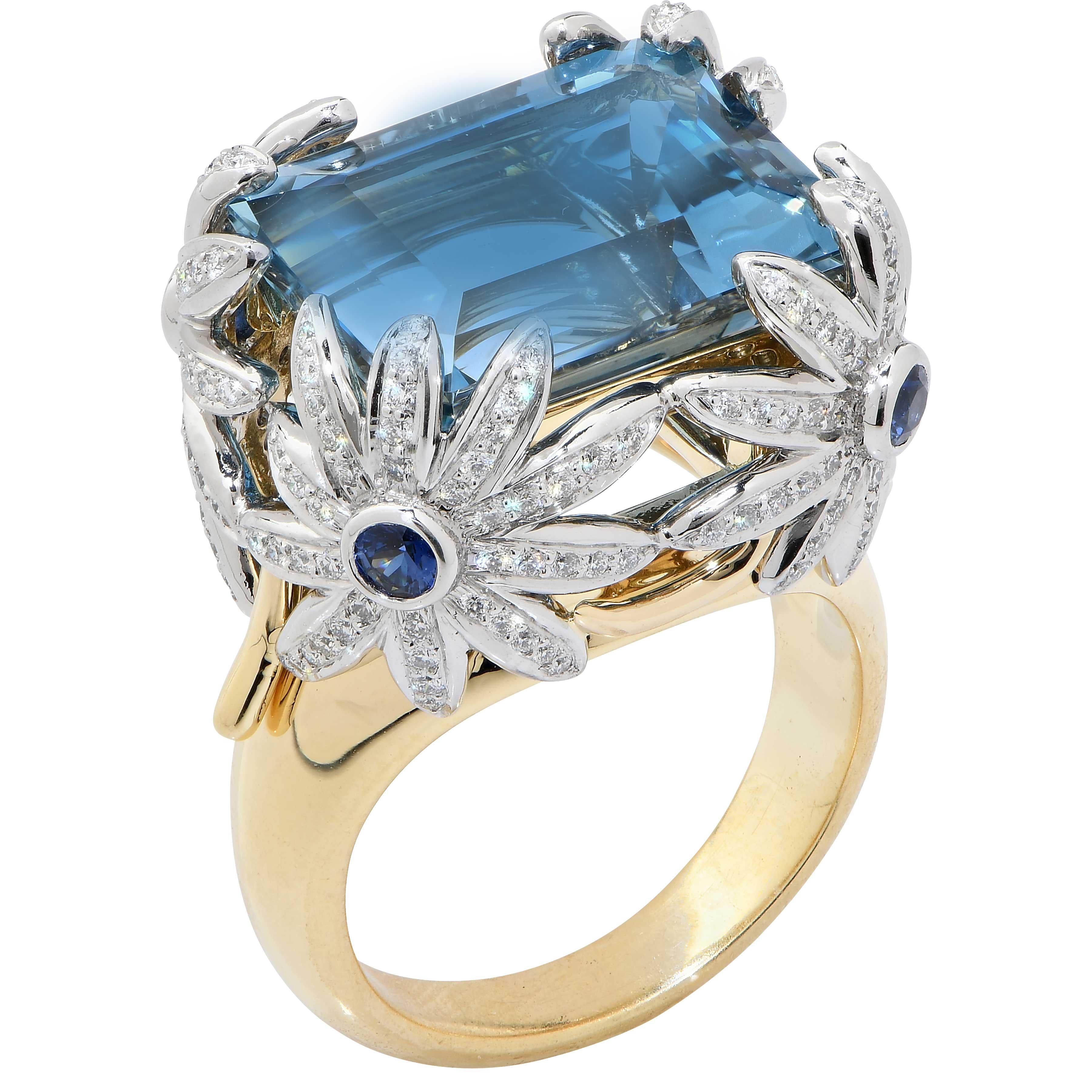 This beautiful ring by Jean Schlumberger denotes the artist's gift for whimsy and incorporation of natural motifs in his work. The ring features an 11 carat fine aquamarine as well as diamonds and sapphires. Four daisy blossoms hold the aquamarine