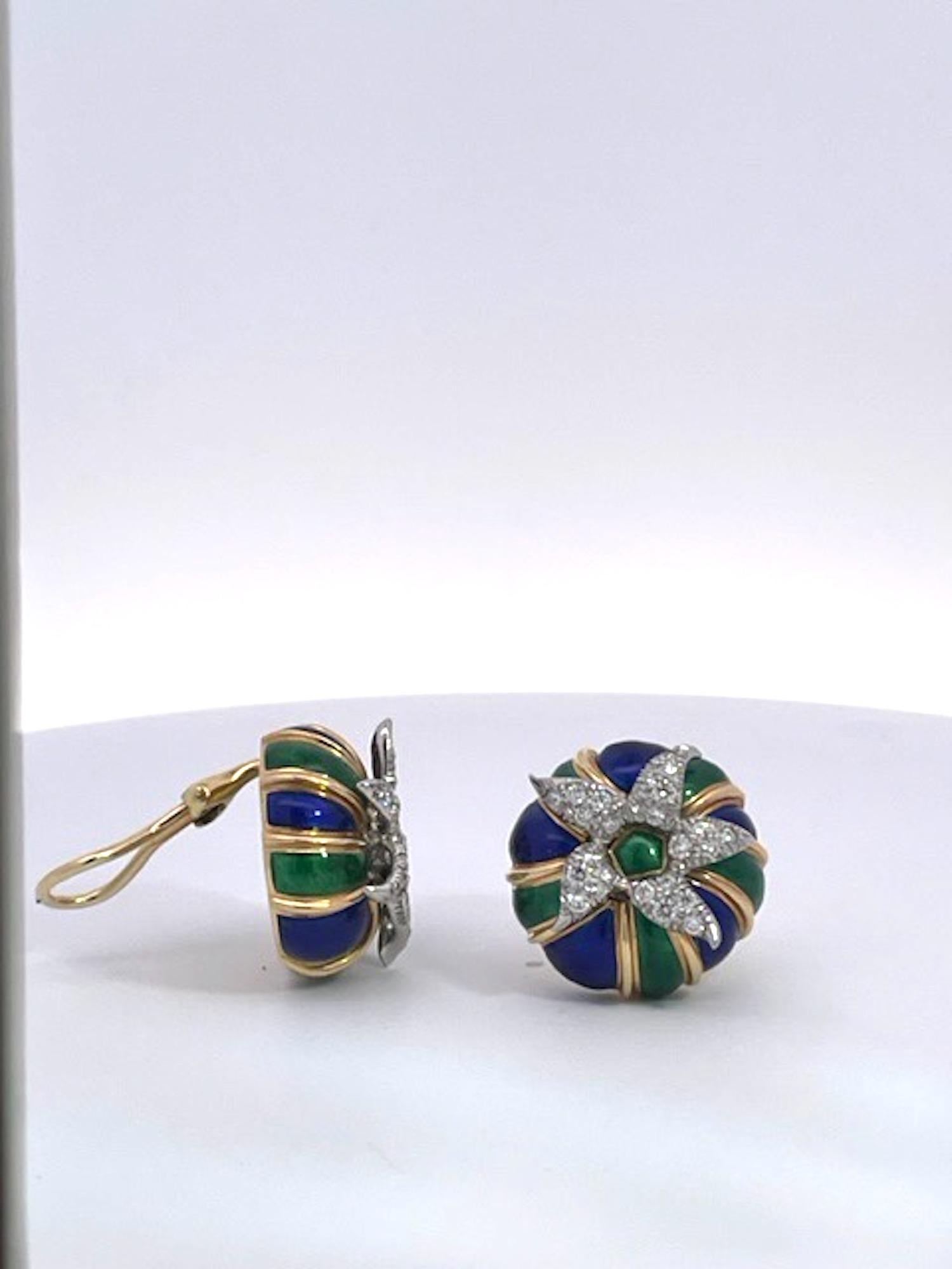 These Schlumberger earrings are special.  They are set in 18K Yellow Gold with Blue and Green enamel and a Diamond starburst in the center.  The Diamonds are set in Platinum as all Schlumberger  pieces are and these are round.  They measure