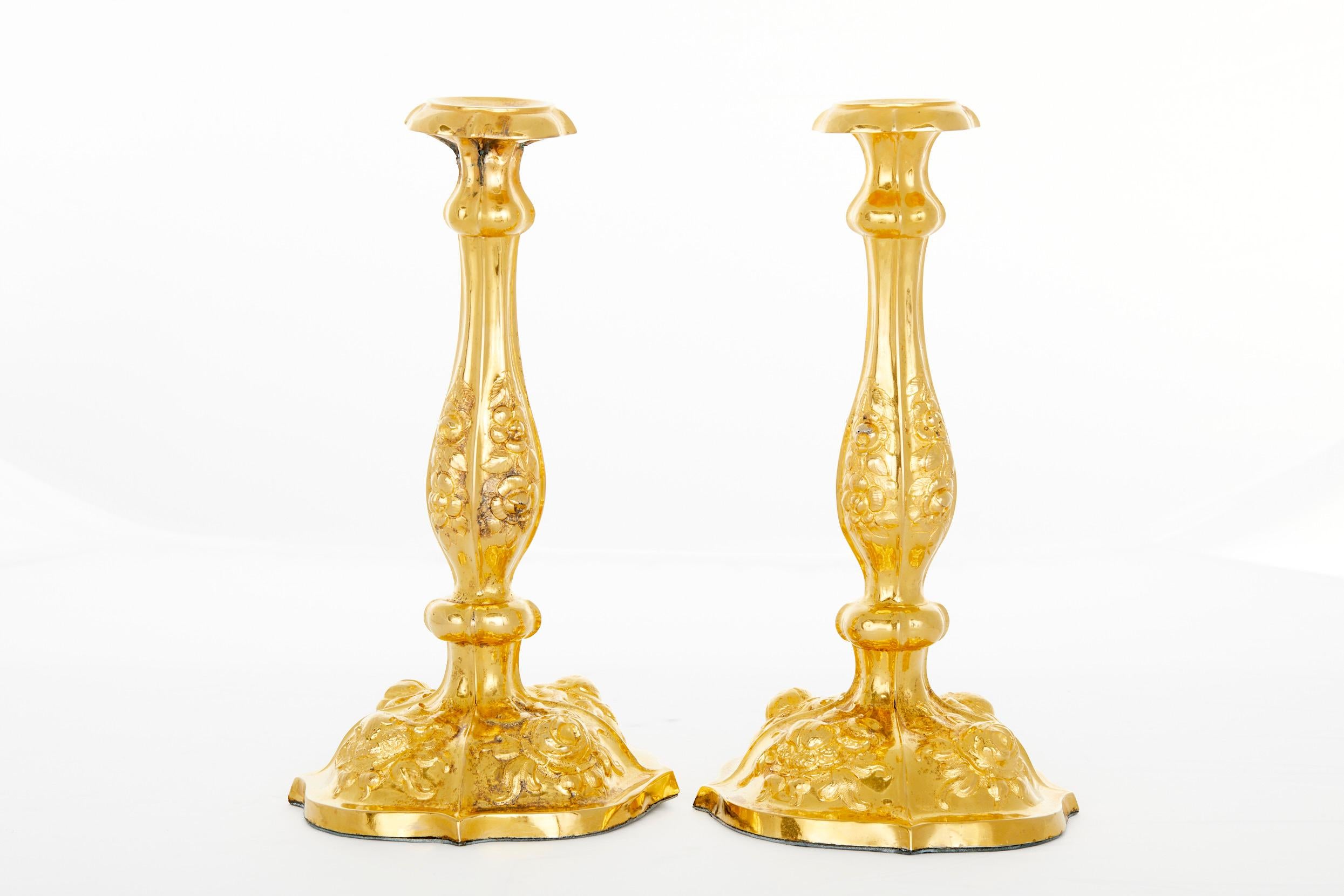 Tiffany & Co. silver gilt pair of decorative continental style tableware candlesticks with exterior floral design details. Each candlestick is in great condition. Lacking nozzles. Minor wear / oxidation to the gilding. Weighted. Maker's mark