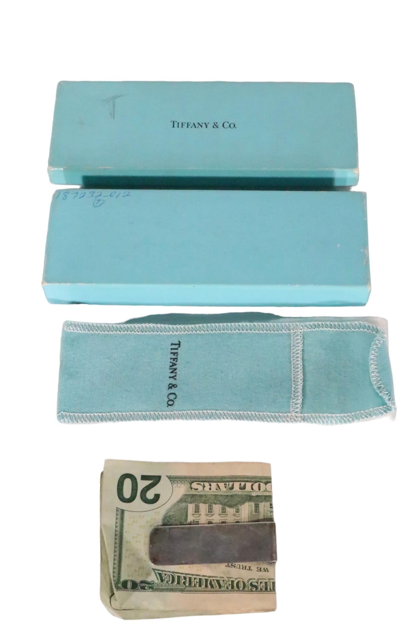 Timeless, chic and always voguish, Tiffany Sterling money clip. The clip is in good, original condition, showing some cosmetic wear, normal and consistent with age. It came to me with the box, and pouch shown, and they are included in the lot,