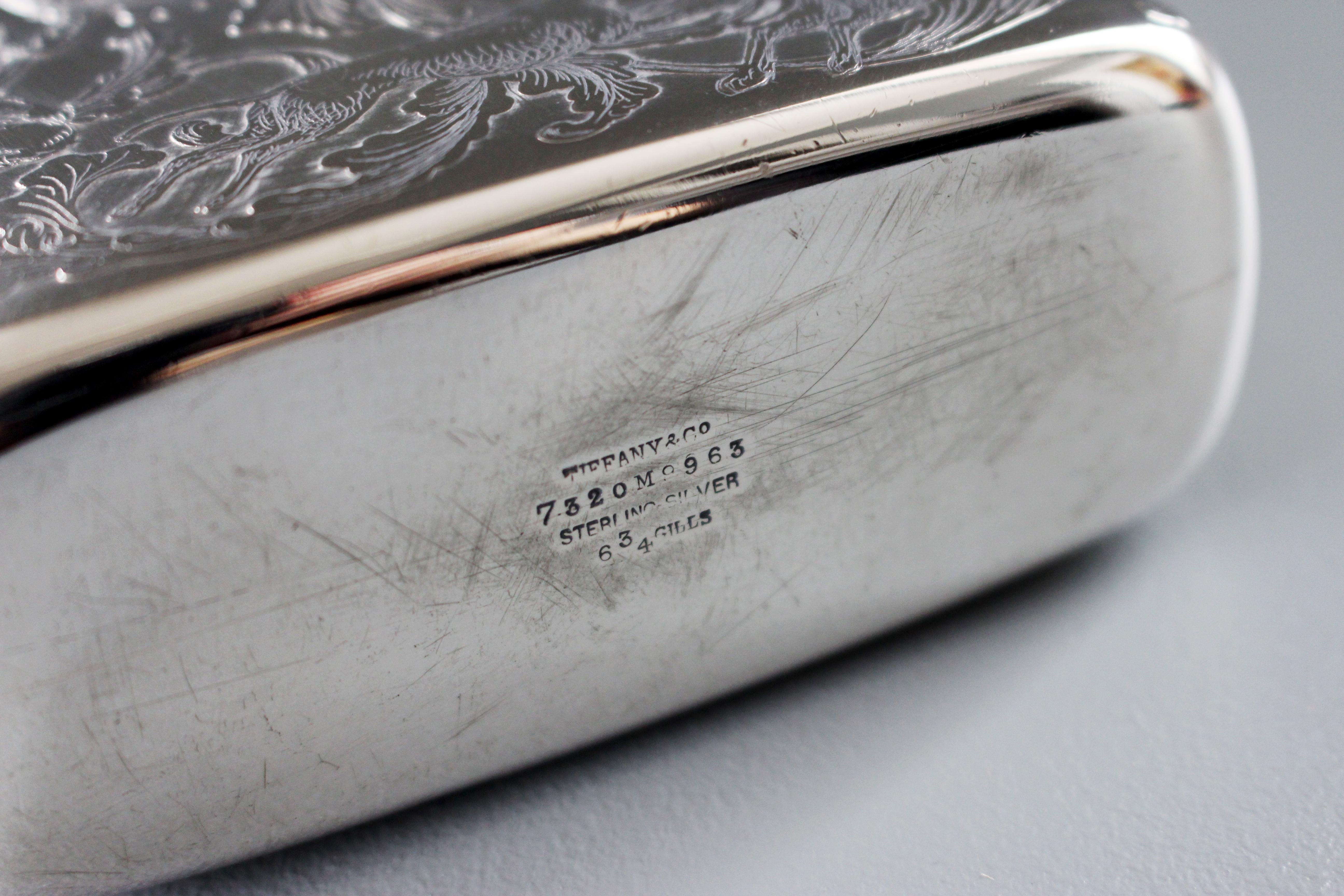 A large American silver spirit flask, by Tiffany & Co., circa 1880, Edward C Moore era, one side chased with hunting scenes, the reverse with cartouche on a floral ground.