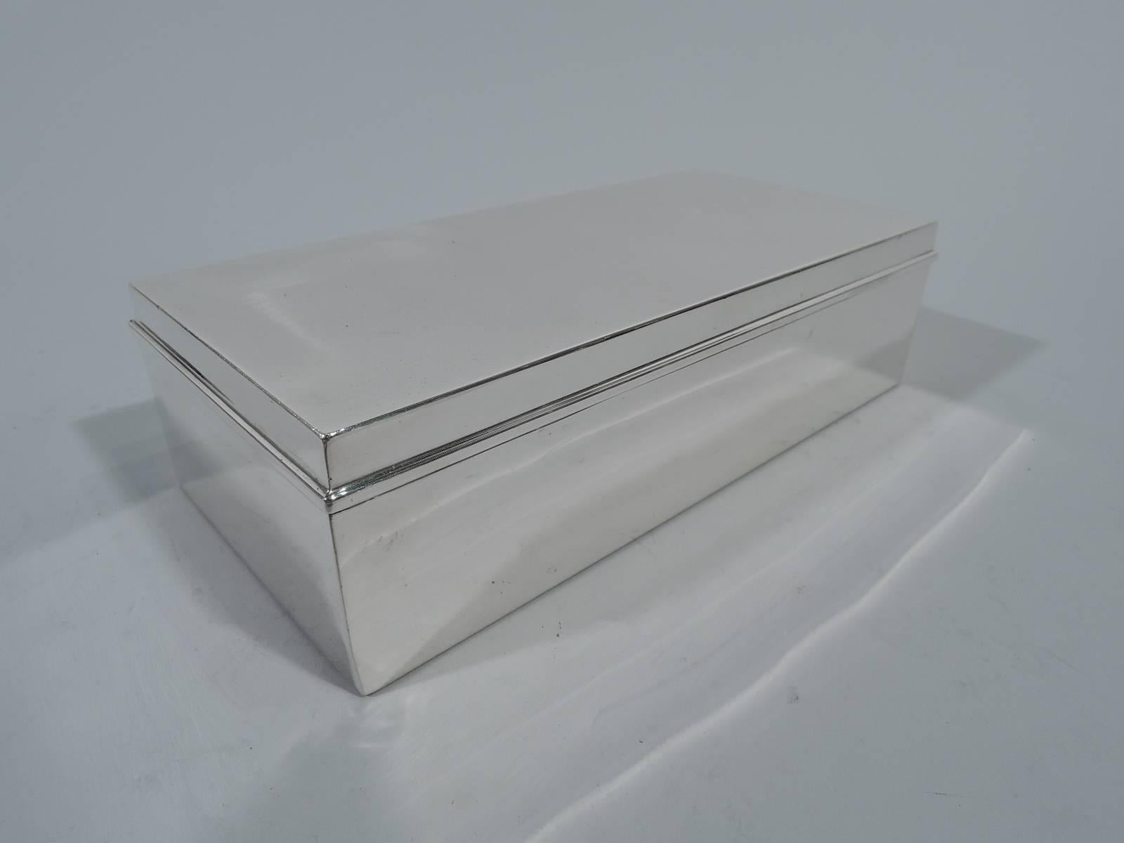 Smart and modern sterling silver desk box. Made by Tiffany & Co. in New York, circa 1936. Rectangular with straight sides and sharp corners. Cover hinged with molded rim. Box interior cedar lined. Hallmark includes pattern no. 22353 (first produced