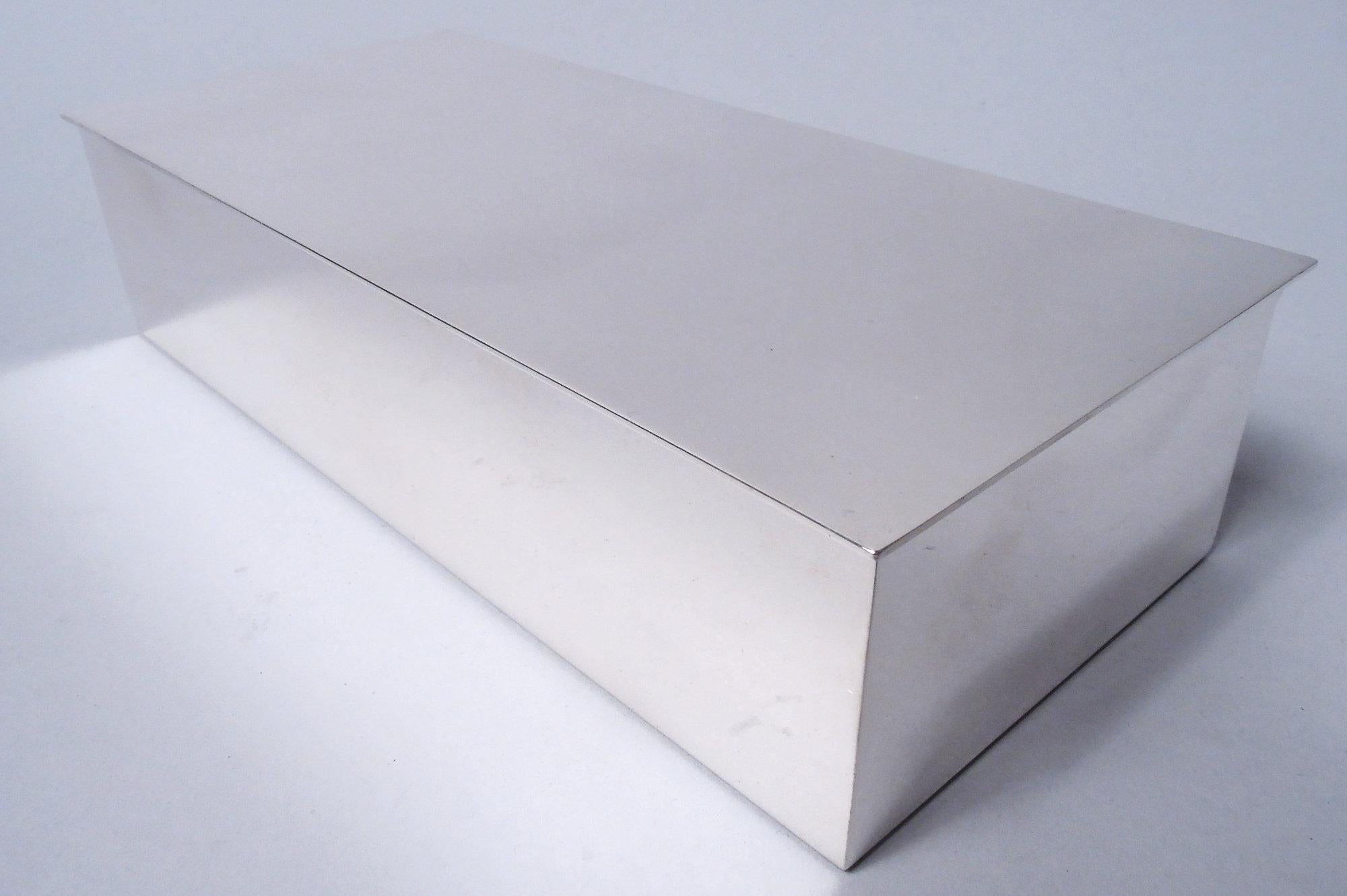Smart and Modern sterling silver box. Made by Tiffany & Co. in New York. Rectangular with straight sides. Cover flat and hinged with slight overhang. Stylish Midcentury design. Fully marked including maker’s stamp, pattern no. 23328, and director’s