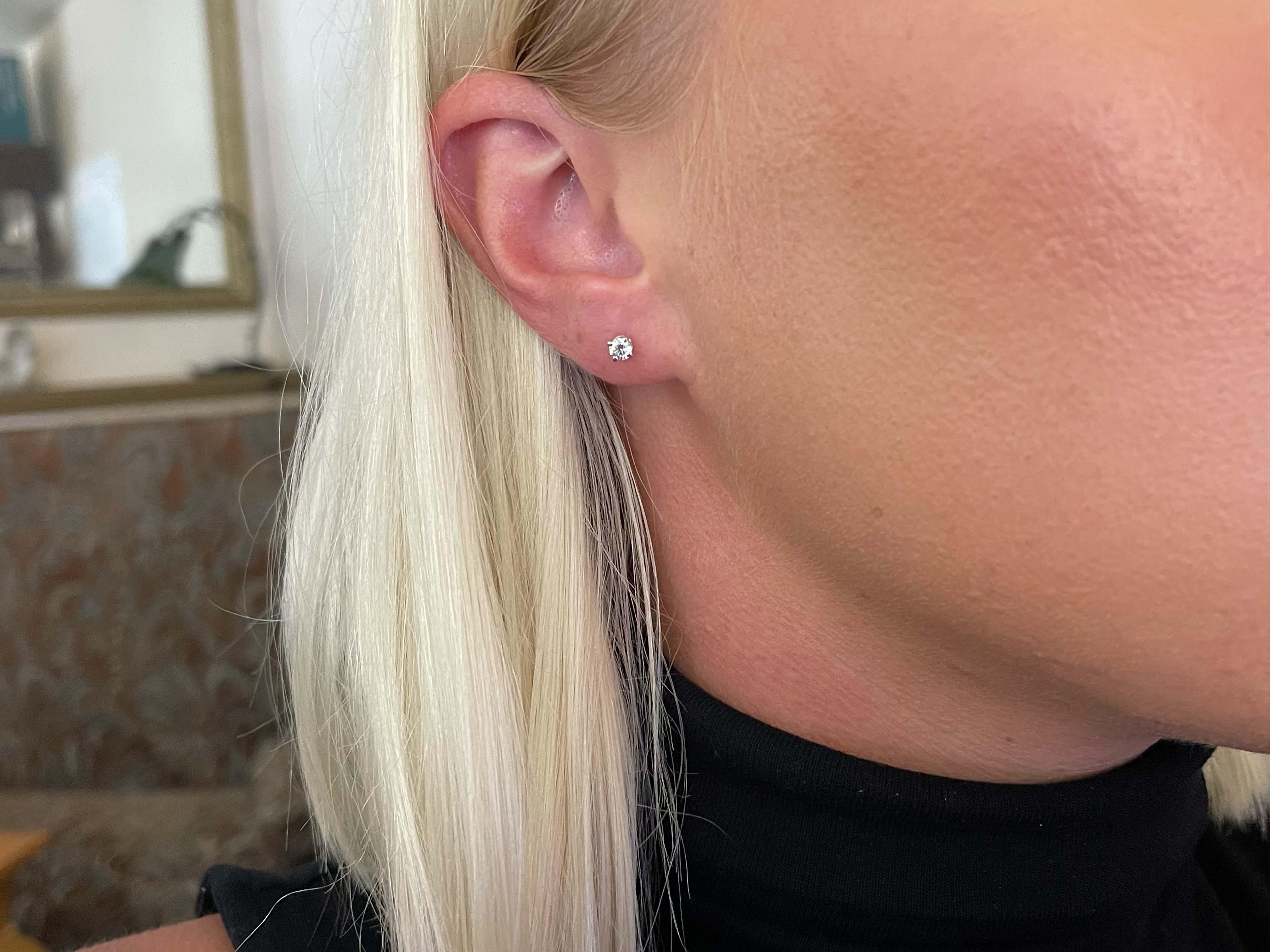 These gorgeous earrings each feature a round brilliant cut diamond prong set, with a total carat weight of 0.29 carats. The diamonds are G, VS1 and have beautiful sparkle. These earrings are beautifully crafted in platinum with a high polished