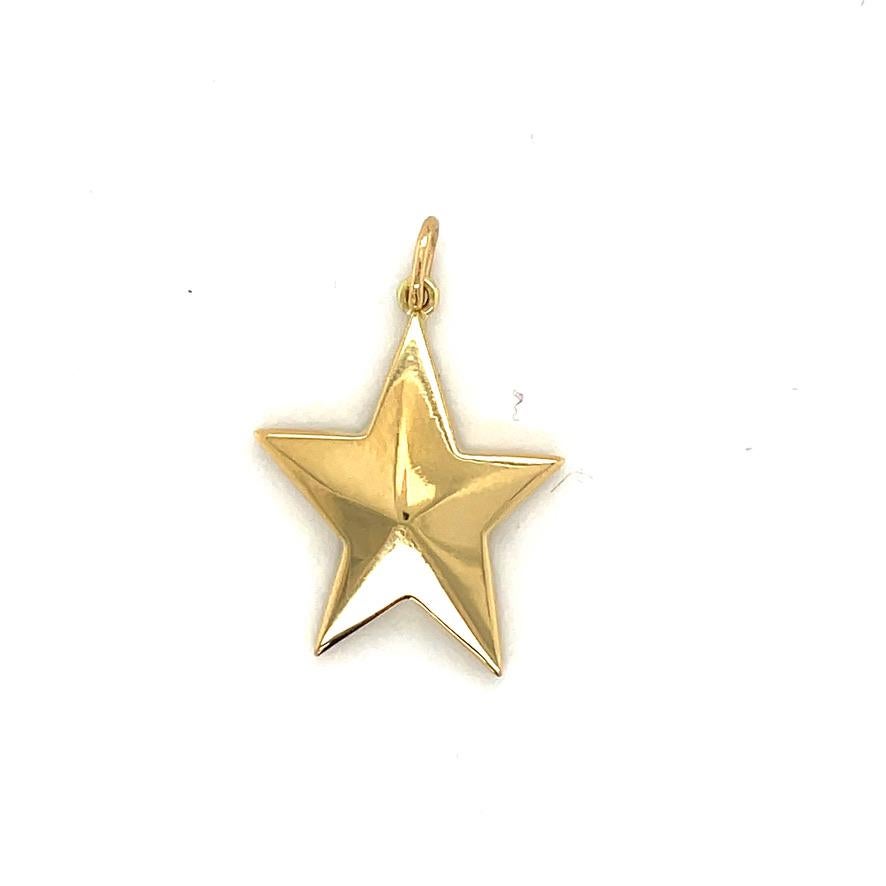 A bright shining star in 18K yellow gold.  Made and signed by TIFFANY & CO.  Interesting slightly irregular configuration, with beveled lines.  2/3