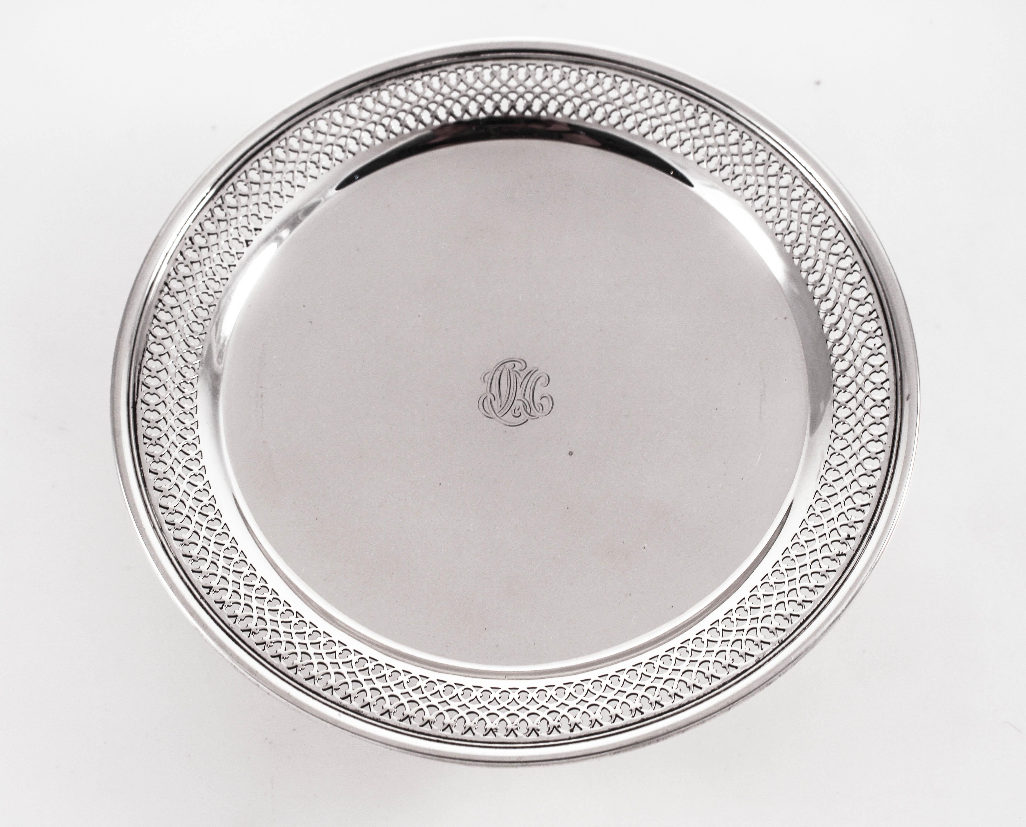 A sterling silver cake plate by the famous Tiffany & Company. It has latticework around the edge and is flat in the center. It stands on a center pedestal and is not weighted. Perfect for a tart or small cake, even finger sandwiches.