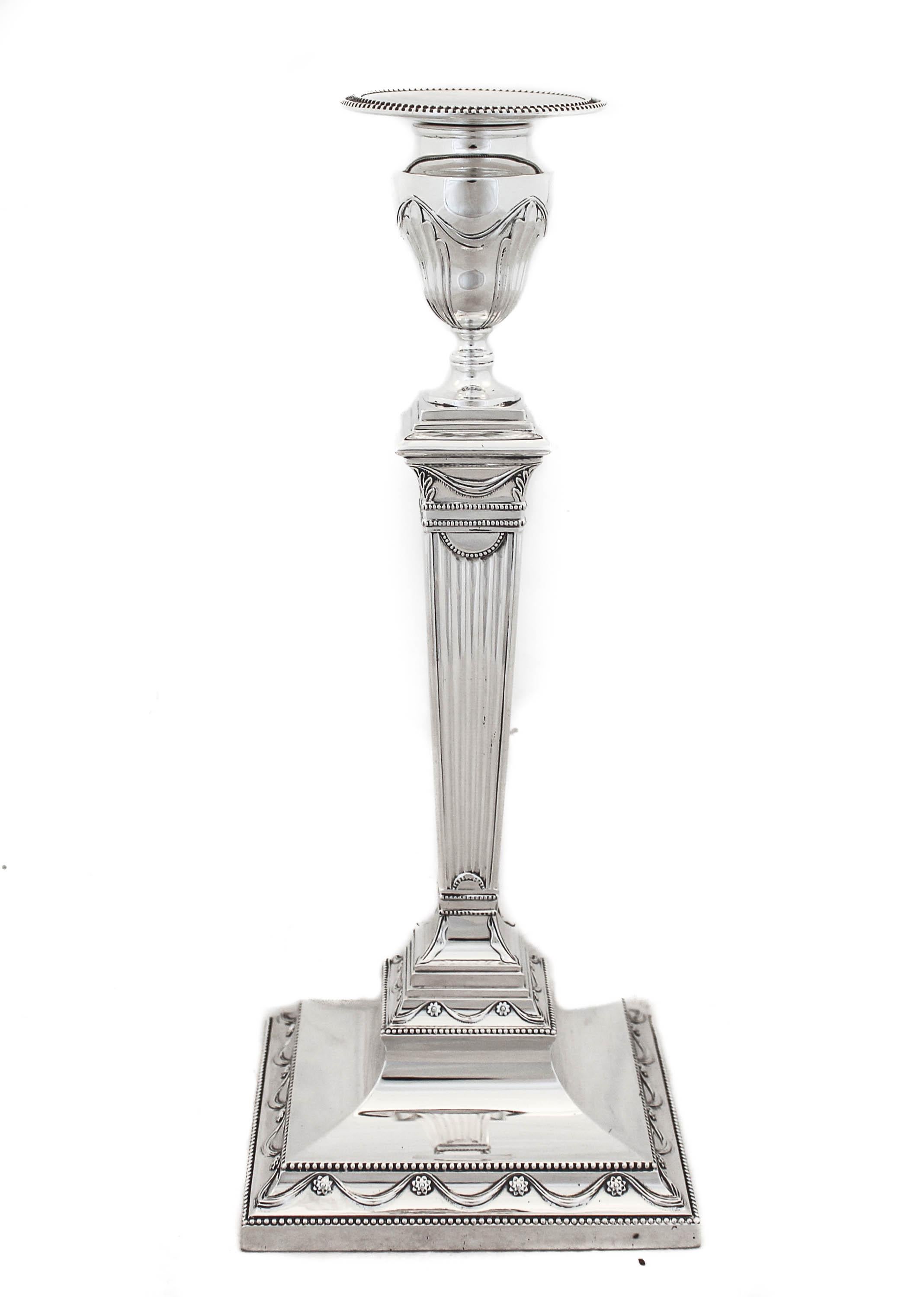 We are thrilled to offer you this pair of sterling silver candlesticks by the world renowned Tiffany & Company. They have a real presence with their large square base and height. The workmanship is exquisite with each detail just perfect. Notice the
