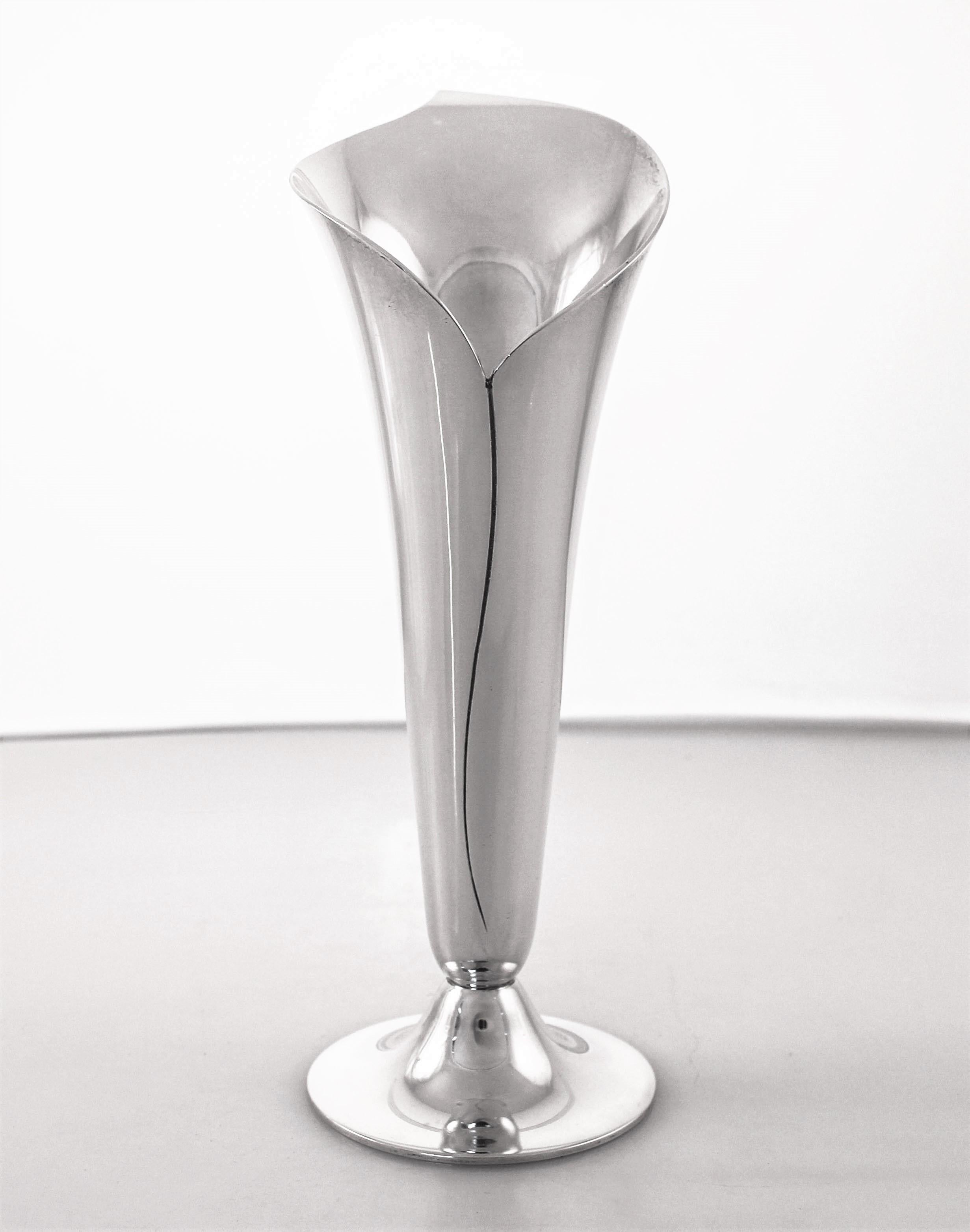 We are proud to offer this pair of midcentury sterling silver vases by Tiffany & Co. They have a sleek and modern design, like a Tulip. Elegant, sophisticated and timeless; exactly what you would expect from Tiffany’s!