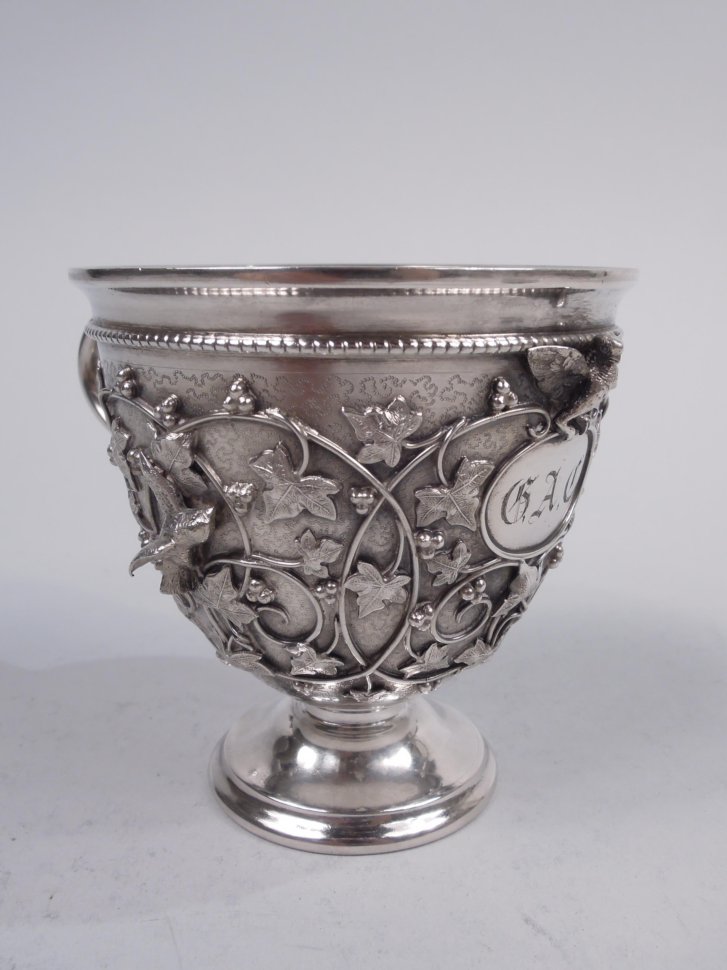 Rare Bird's Nest sterling silver baby cup. Made by Tiffany & Co. in New York, ca 1870. Ovoid bowl on stepped foot. Scroll handle with squiggle tail. Bowl has shaped pointille ornament and wire scrollwork applied with cast fluttering and flapping