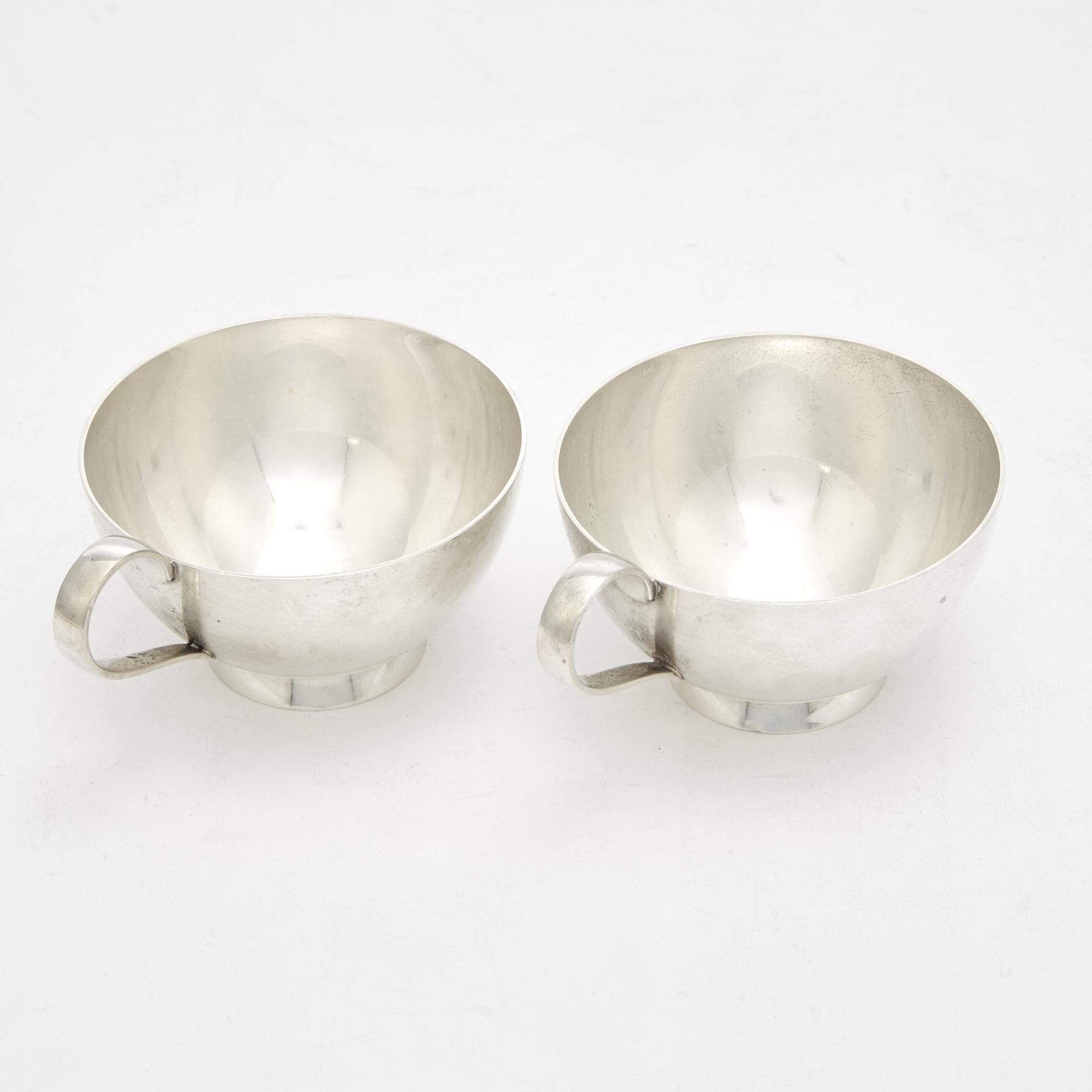 Immerse yourself in the epitome of Art Deco sophistication with our Tiffany & Co Sterling Silver Barware/Tableware Punch Cup Serving Service for Ten People. Crafted by the esteemed Tiffany & Co, this set exudes timeless elegance through its clean
