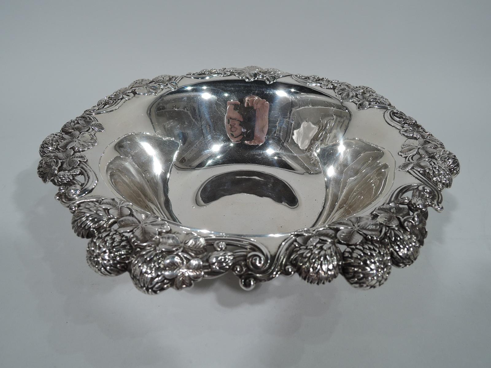 Clover sterling silver bowl. Made by Tiffany & Co. in New York. Tapering sides and turned-down rim with bunched blossoms. An early piece in this Gilded Age high-low pattern that combines wild flowers and precious metal. Fully marked including