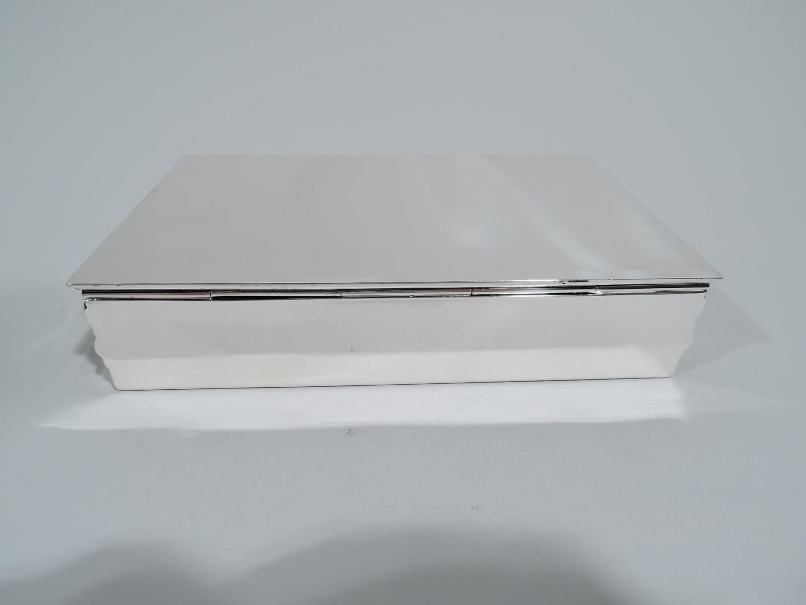 Mid-Century Modern sterling silver box. Made by Tiffany & Co. in New York. Rectangular with flat and hinged cover. Sides and front have chased band of stylized and imbricated chevrons. A stylish revival of a historic 19th century pattern that is