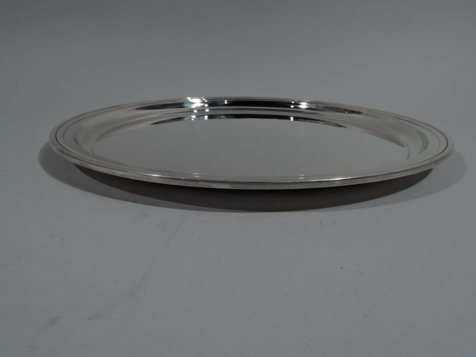 Modern sterling silver serving tray. Made by Tiffany & Co. in New York. Round well and molded rim. Nice heft and proportions. Fully marked including pattern no. 21244, director’s letter m (1907-47), wartime star (1943-5), and diameter. Weight: 30.5