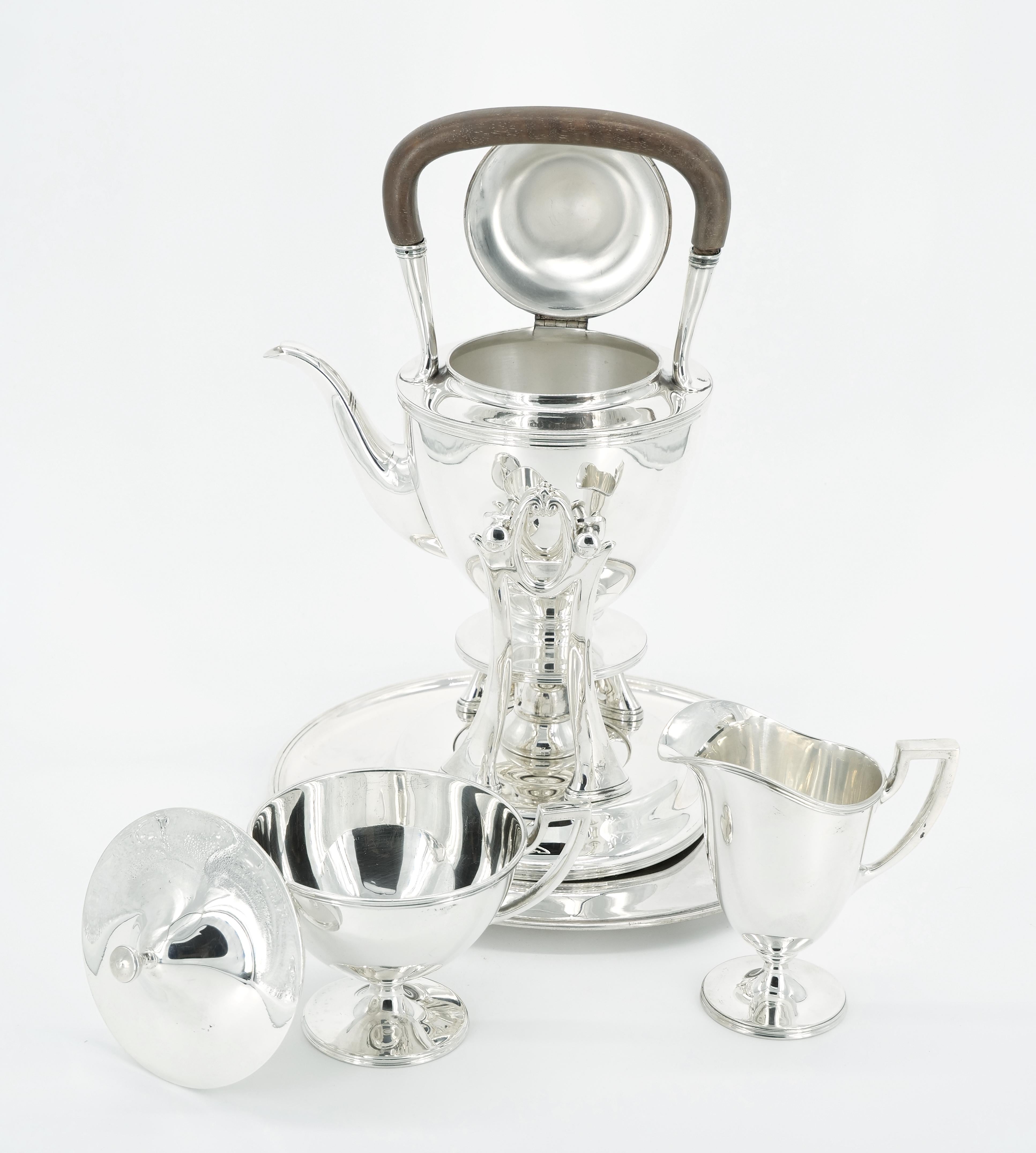 Indulge in the timeless elegance of this Exquisite early 20th-century Tiffany Sterling Silver Classical Style Four-Piece Tea/Coffee Service. Each piece is a testament to Tiffany's renowned craftsmanship, featuring a clean and classic line design