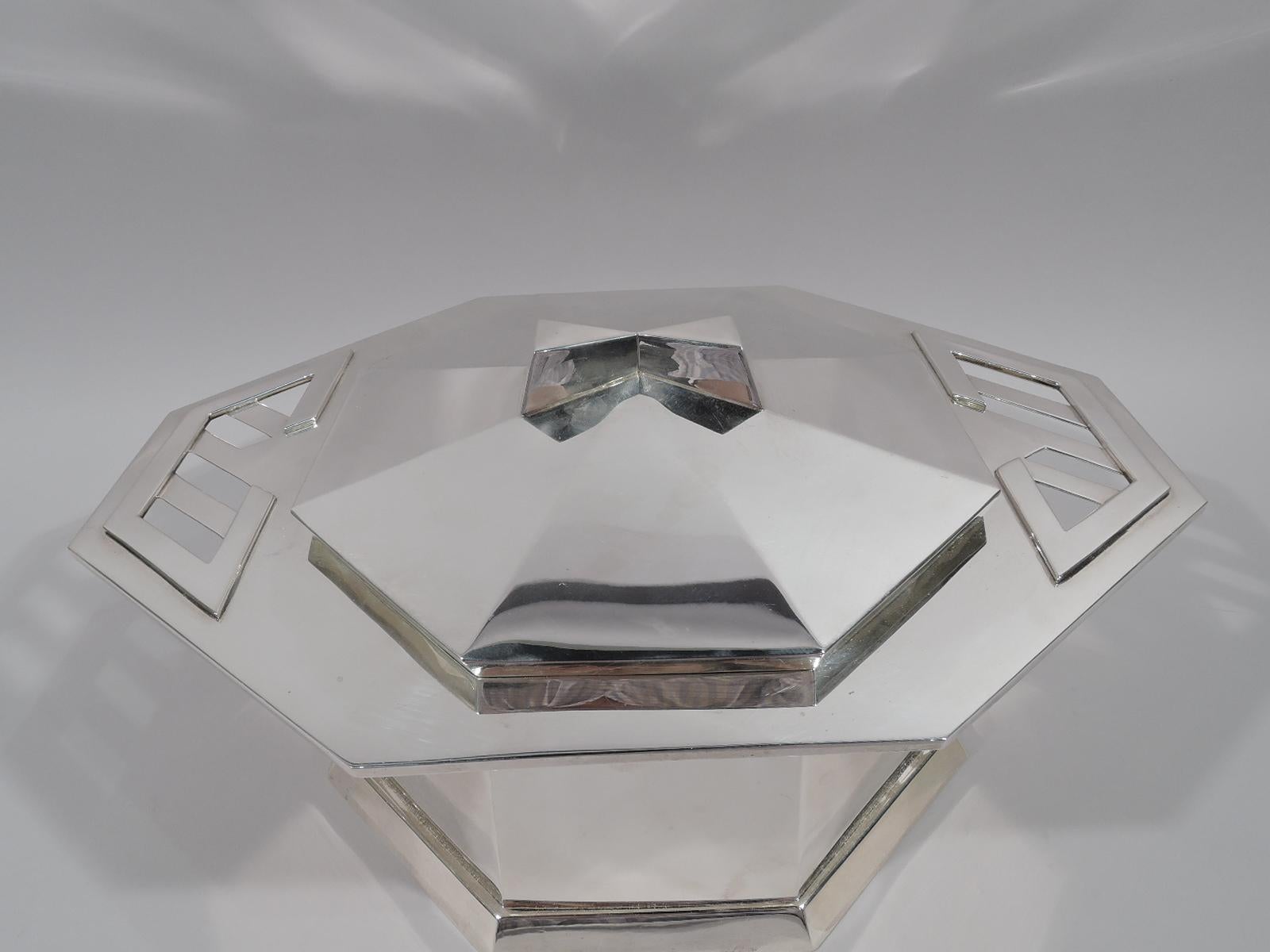 Art Deco sterling silver covered tureen after design by Frank Lloyd Wright. Retailed by Tiffany & Co. in New York. Octagonal bowl and wide and overhanging rim with applied and cutout Modern fretwork handles. Spread base. Raised cover with soft