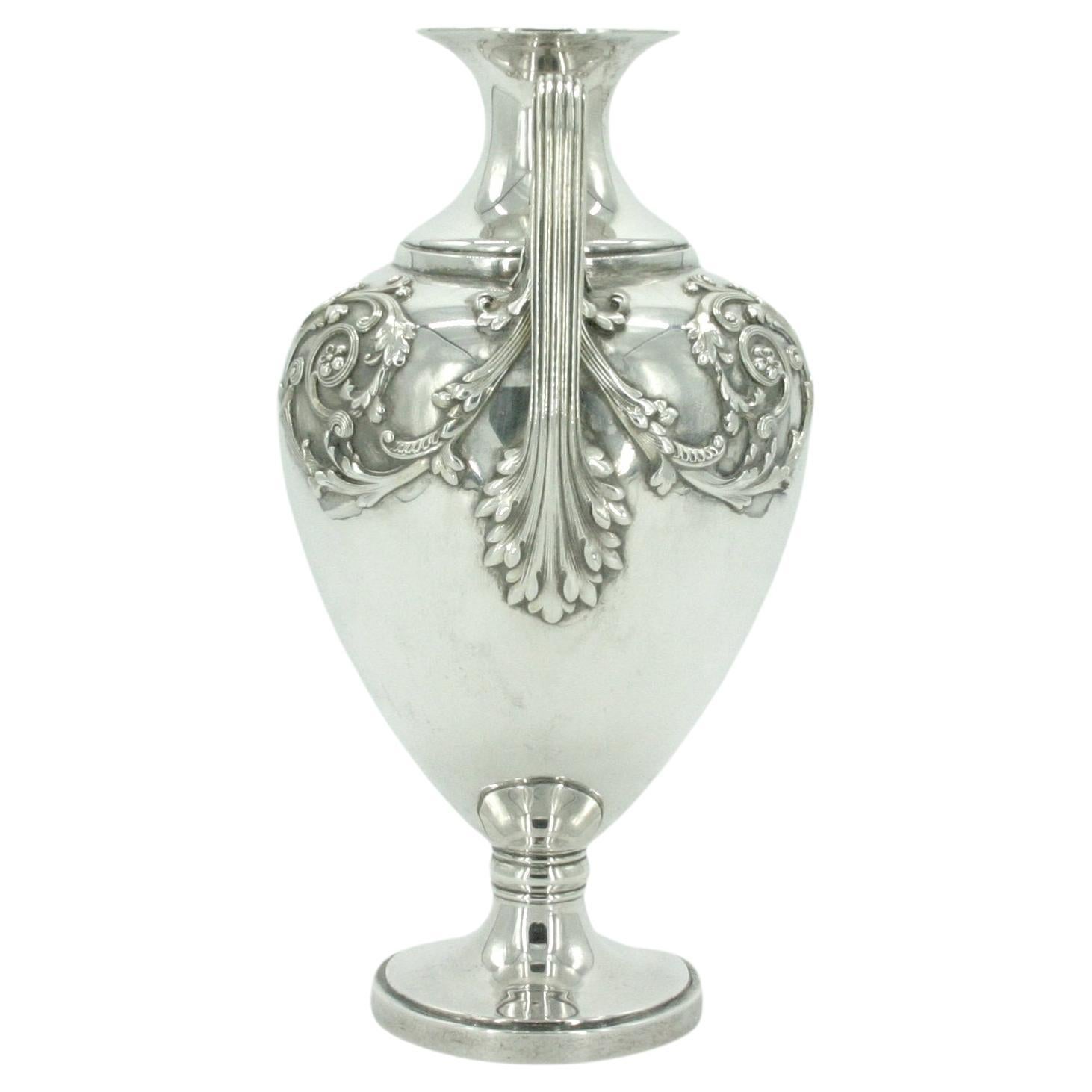 19th Century Tiffany & Co. sterling silver decorative footed vase / piece. The vase features exterior floral design with two side handles resting on a proportions round base. The vase is in great condition. Minor wear. Marked 