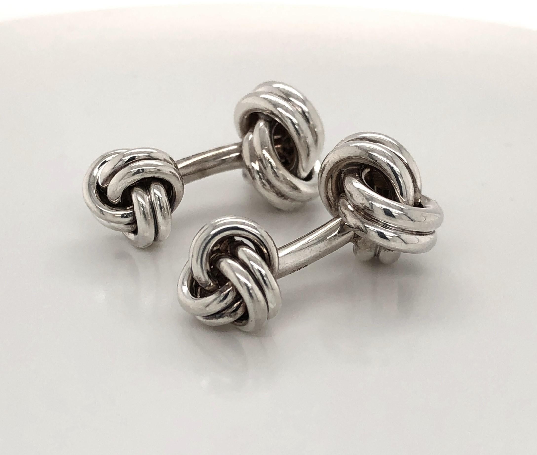 Tiffany Sterling Silver Double Knot Cuff Links. Reversible, fixed back style. Larger knot measures approx 12.25 mm x 12.75 mm. The smaller knot measures approximately 8.5 mm x 10.5 mm. Signed by maker. In gift box.