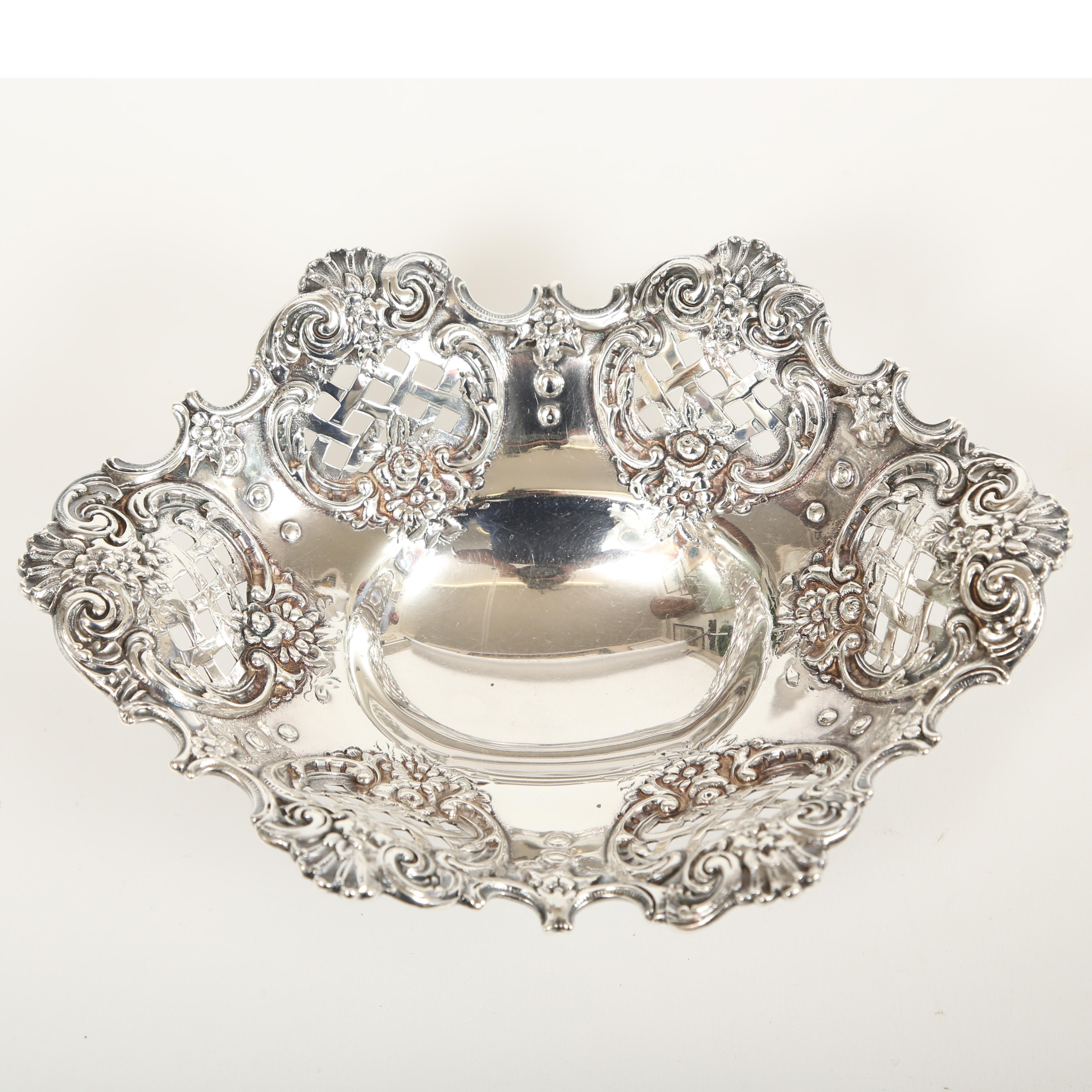 Tiffany sterling silver footed bowl. The work on the sterling silver is pierced, reticulated and repoussage. The latticed design is surrounded by flowers, 